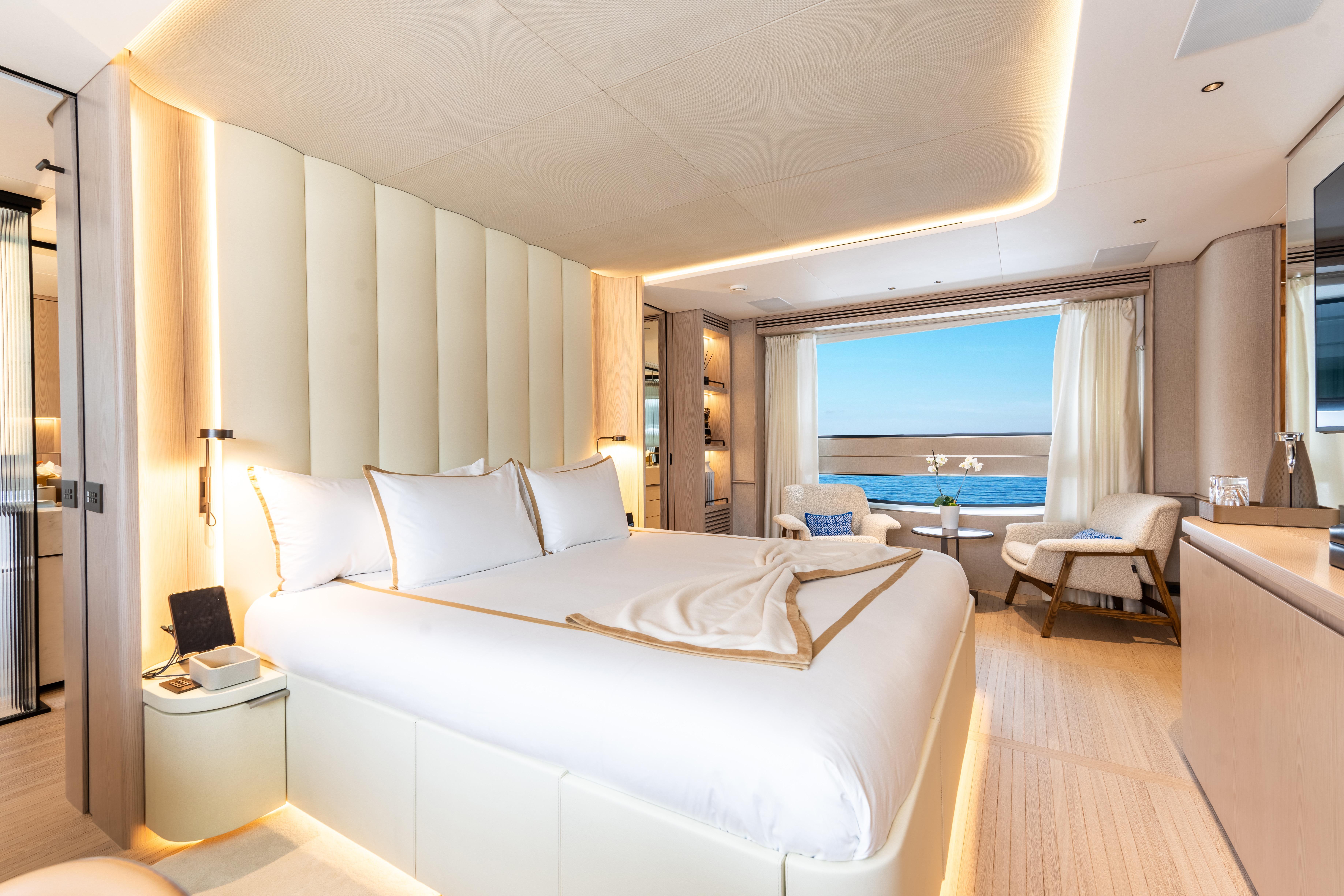Luxurious 2024 Benetti Oasis yacht bedroom with ocean view, elegant decor, and modern amenities.