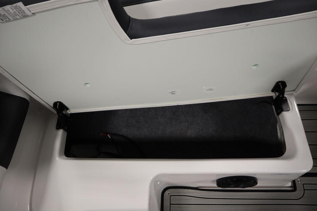 Open storage compartment in 2026 Yamaha Boats 195S, showcasing spacious interior design.