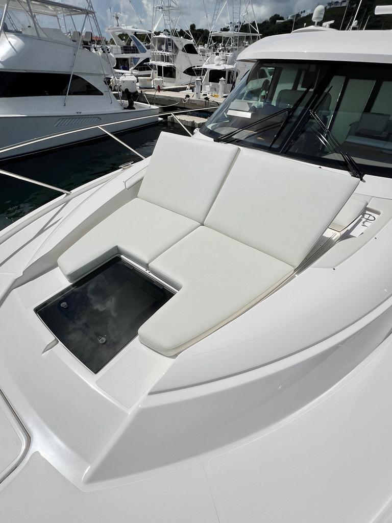 2023 Tiara Yachts C49 Coupe with sleek white deck seating.