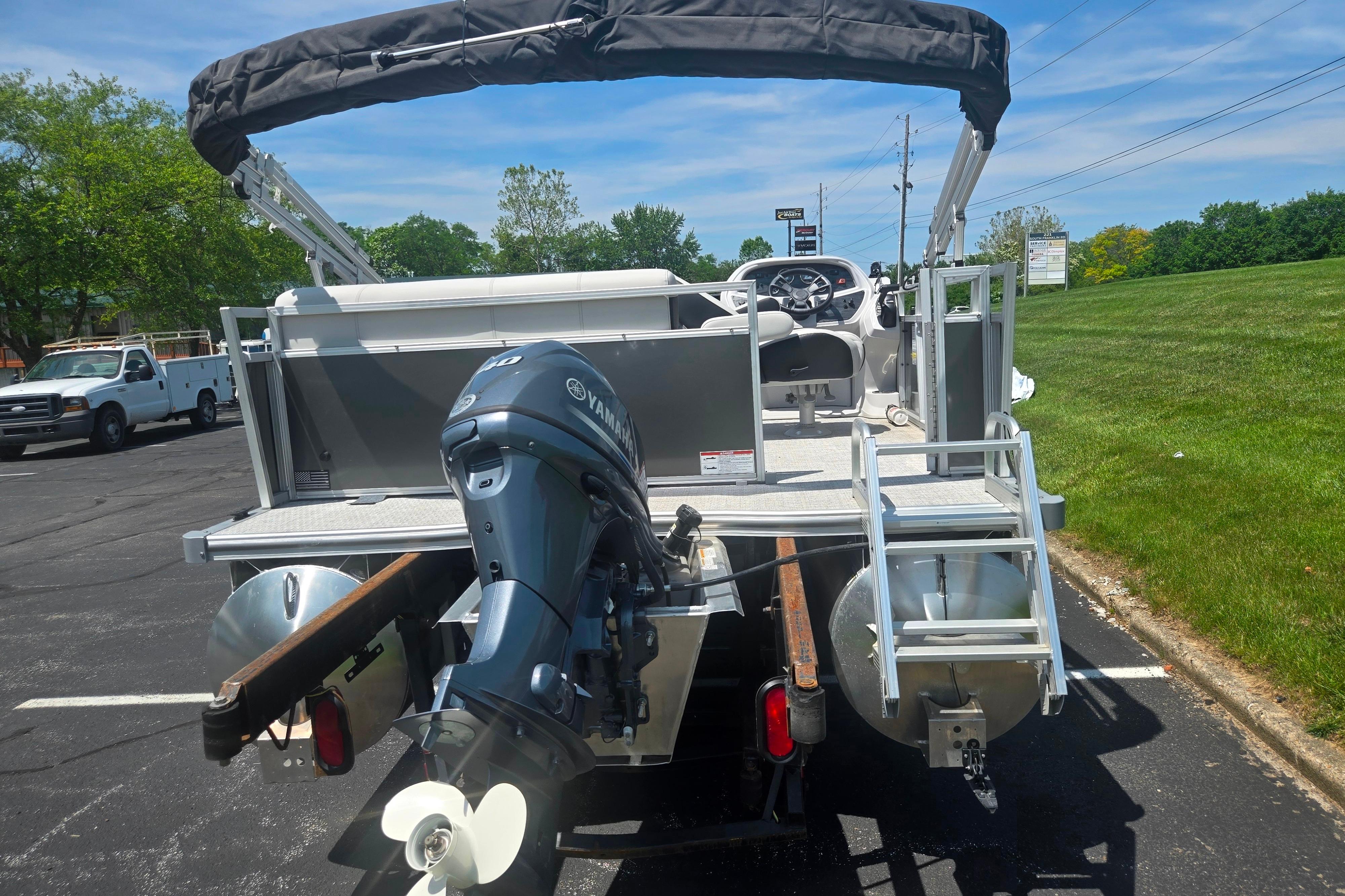 2025 Trifecta 16FC pontoon boat with Yamaha outboard motor, parked on asphalt.