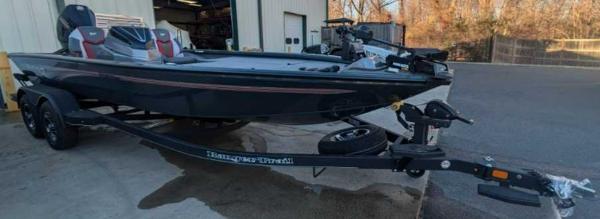 2025 Ranger ALPHA 208 boat on trailer outside a garage.