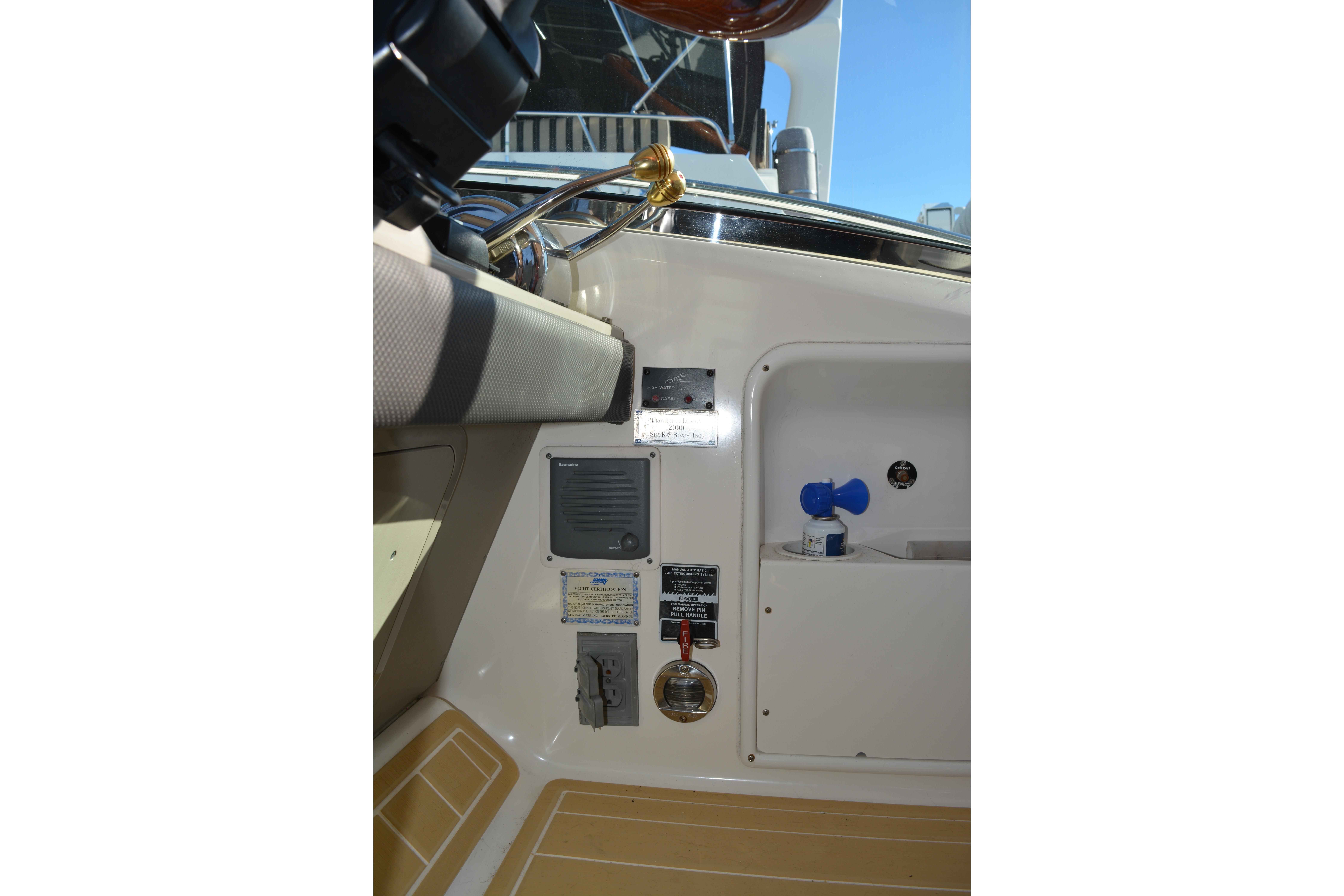2007 Sea Ray 44 Sundancer cockpit controls and storage compartment.