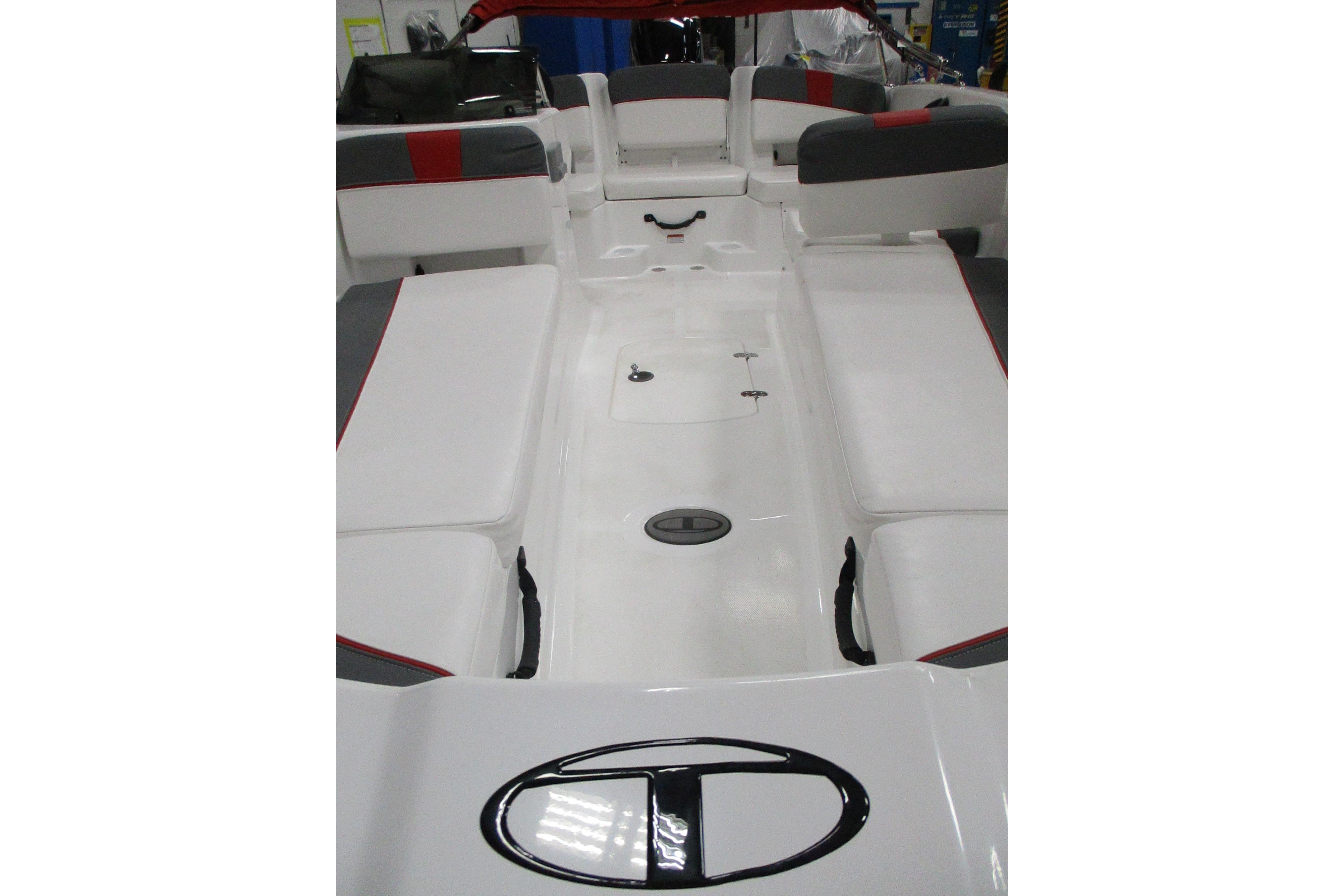 2025 Tahoe T18 boat interior with white and gray seating, red accents.