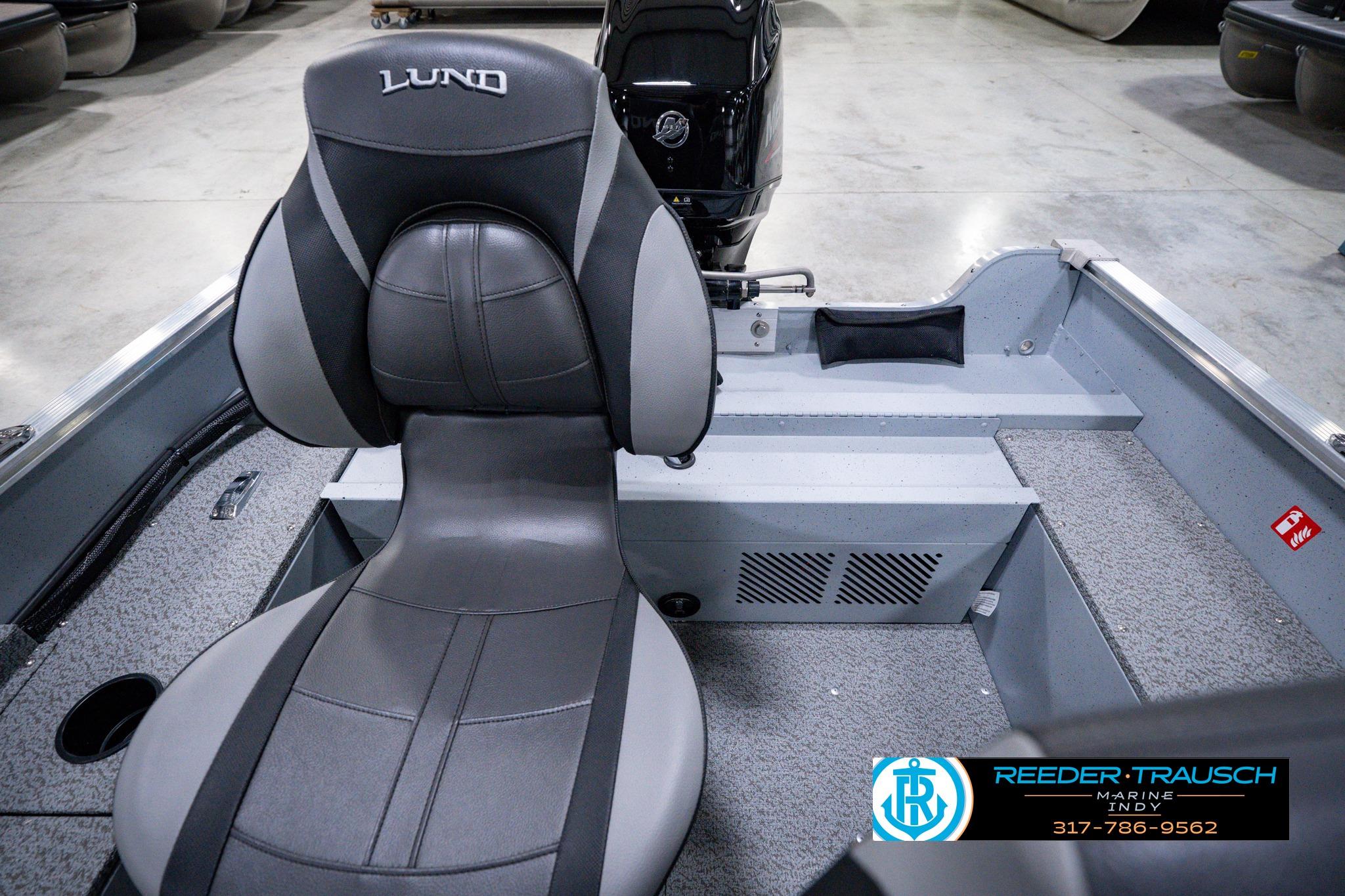 2026 Lund 1600 Fury SS boat interior with gray seating and carpeted flooring.