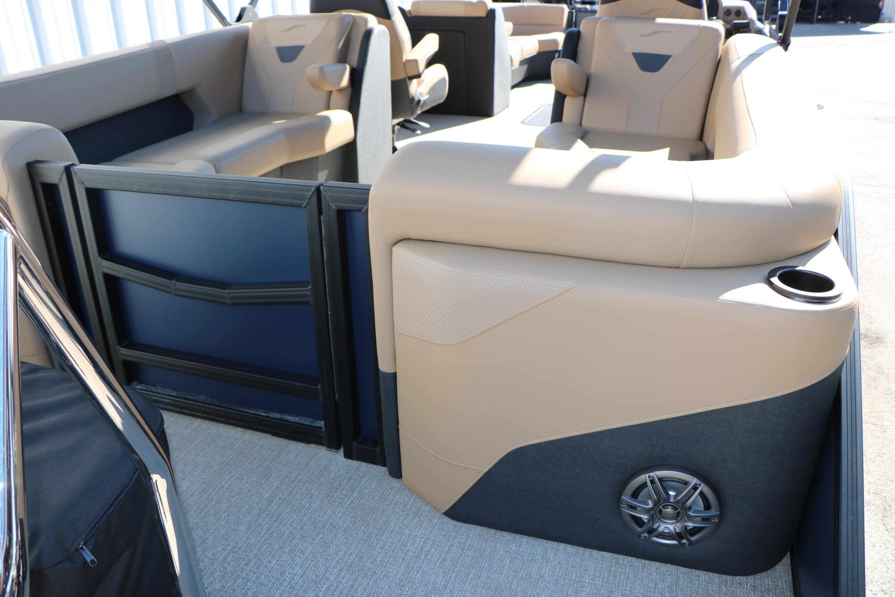 Interior of 2026 Evotti 525 QL Tri-Toon boat with beige seating and speaker.