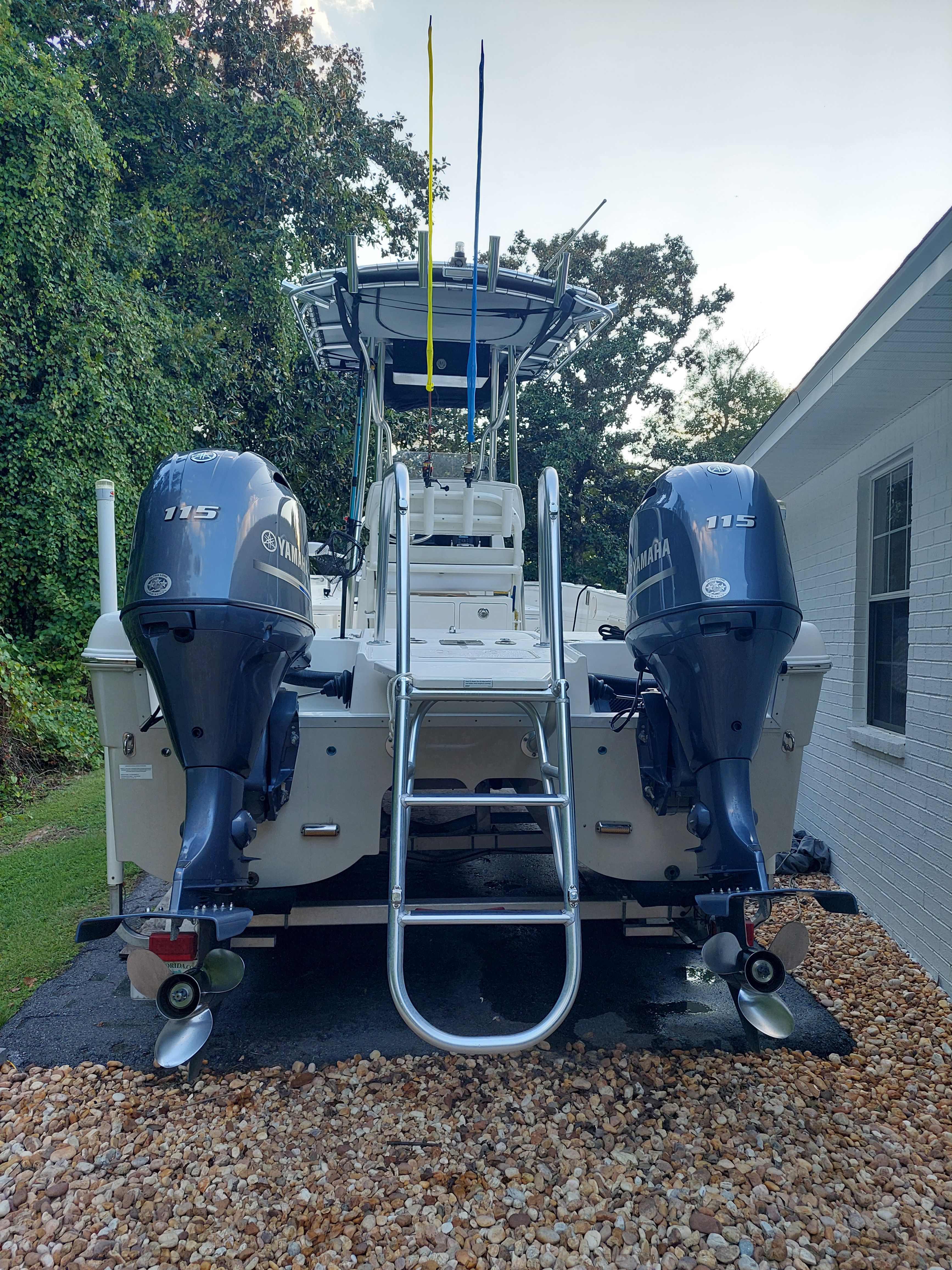 2020 World Cat 230 CC boat with Yamaha engines in backyard.