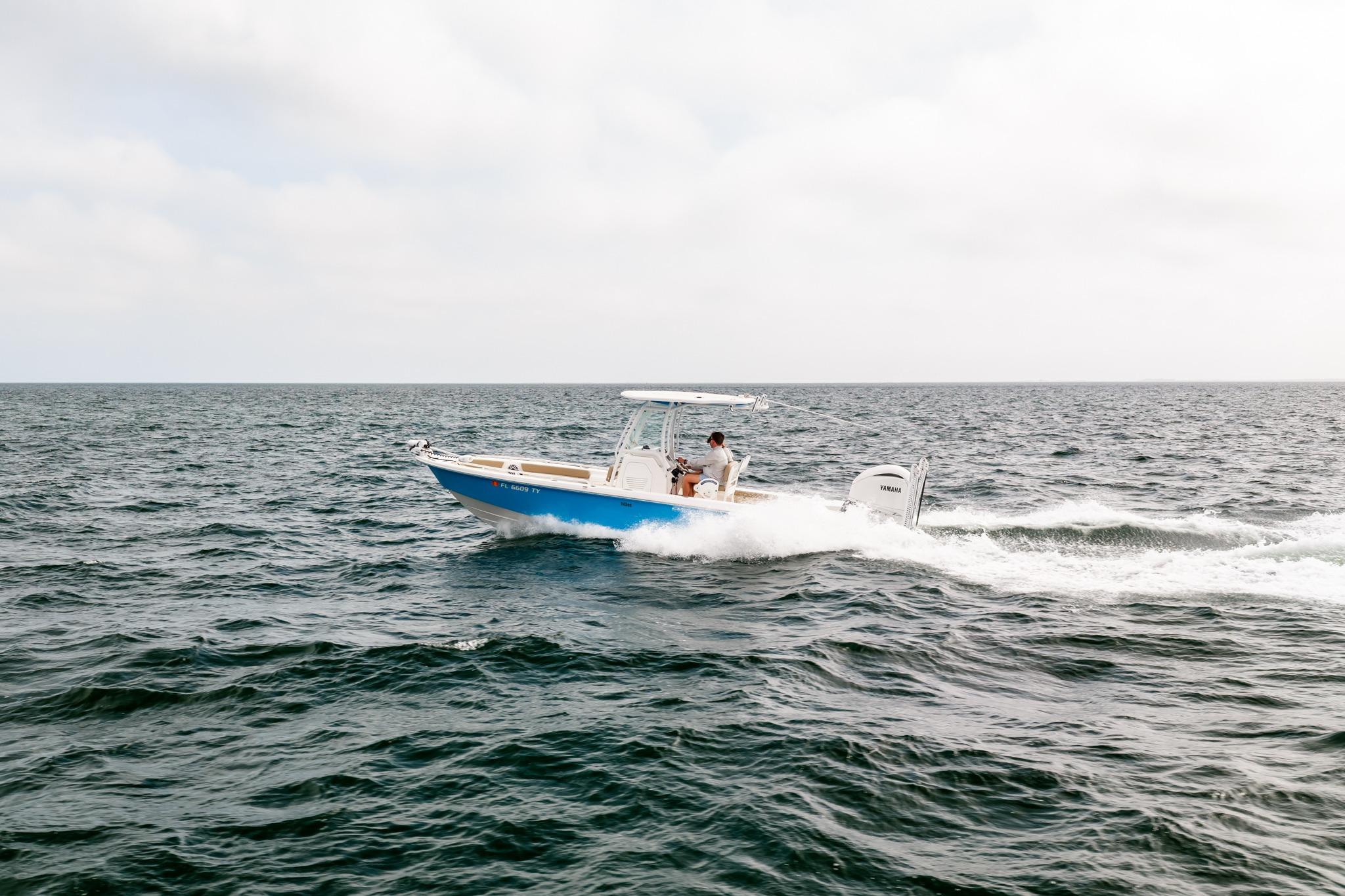 2023 Everglades 243 Center Console boat cruising on open water.