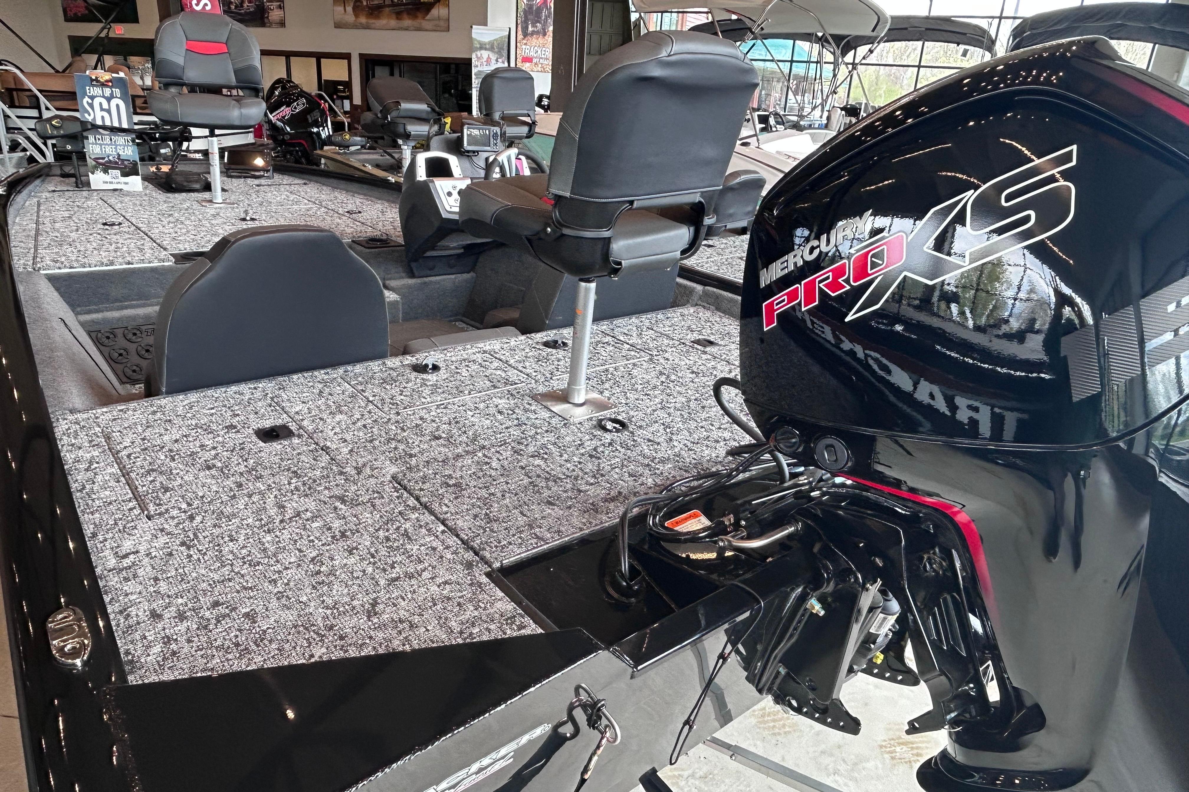2026 Tracker Pro Team 195 boat with Mercury Pro XS engine in showroom.