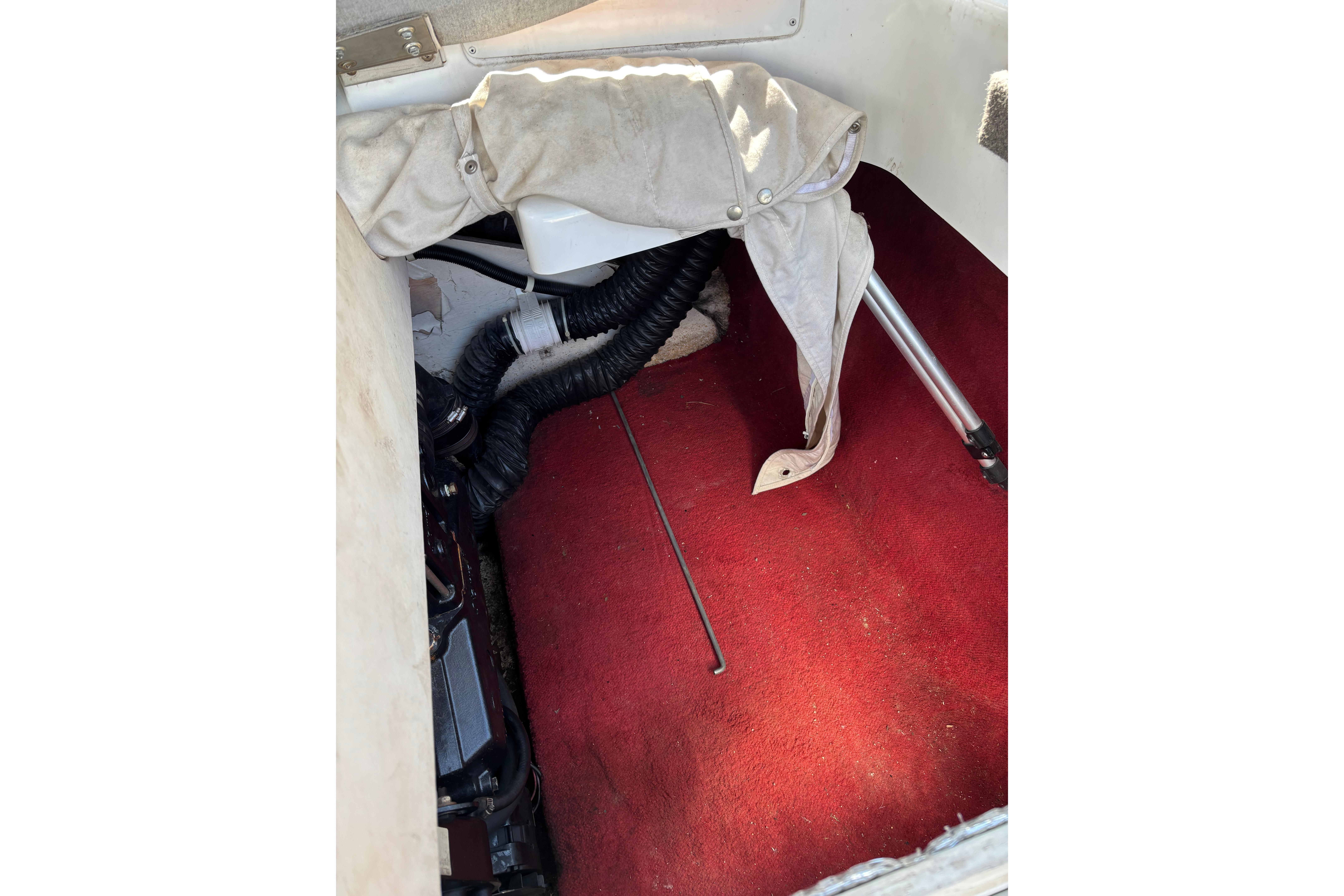 Interior of 1993 Larson SEi 200 Cuddy I/O boat with red carpet and equipment.