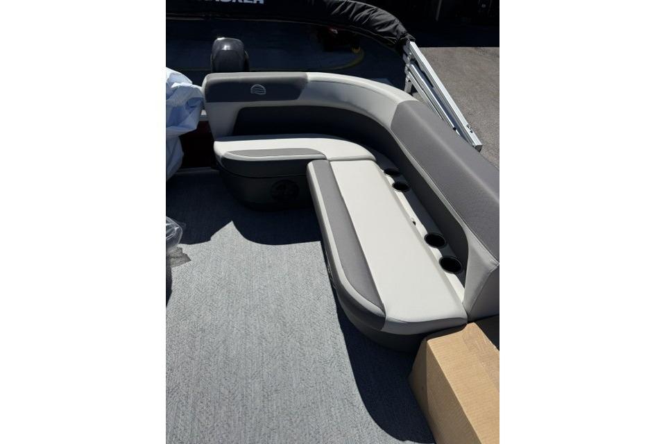 2026 Sun Tracker Bass Buggy 16 XL Select pontoon boat with gray seating and cup holders.