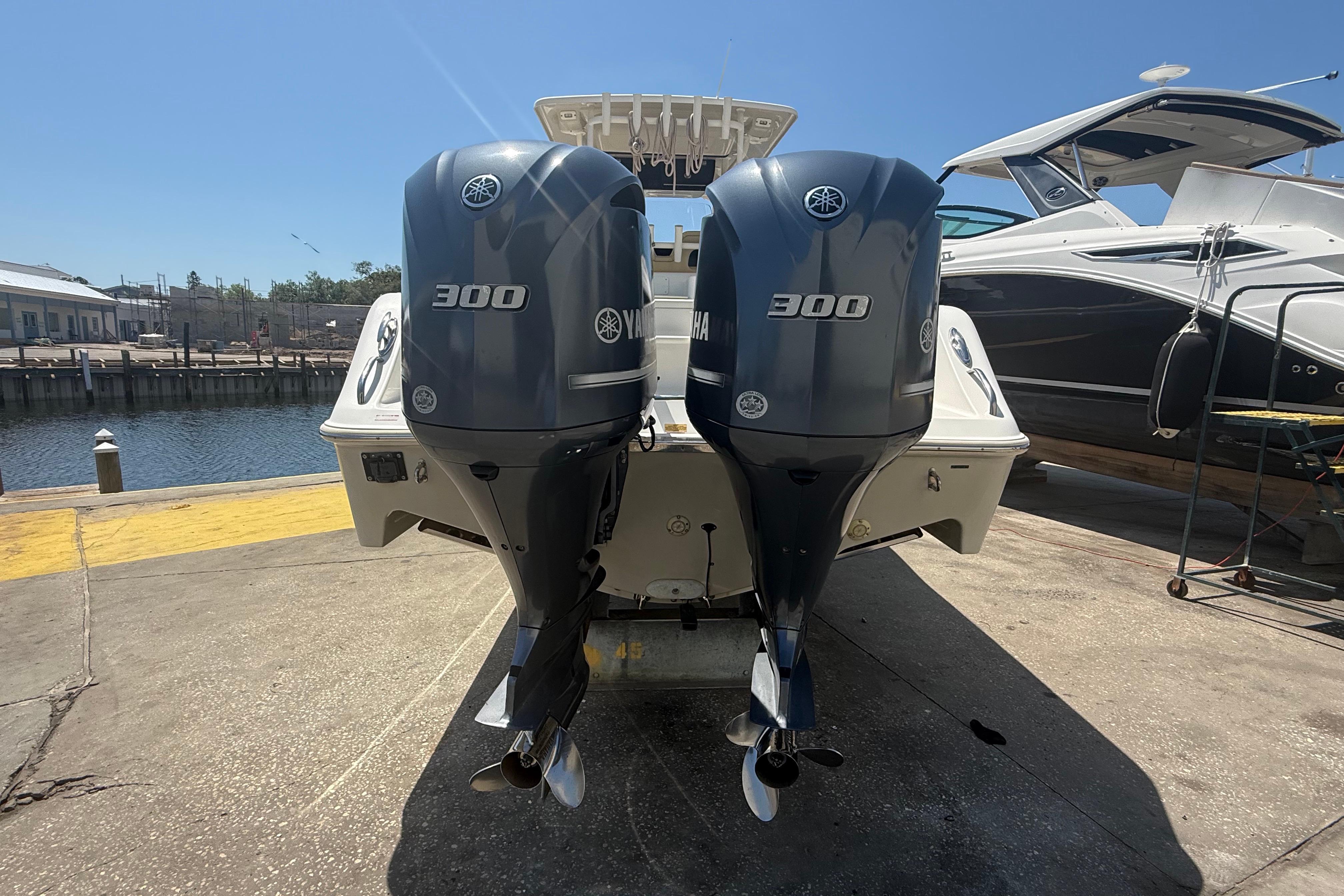 2019 Key West Billistic 281 Center Console with twin Yamaha 300 engines at dock.