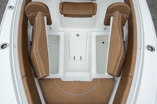 2026 Sea Hunt Ultra 255 SE boat interior with tan seating and storage compartments.