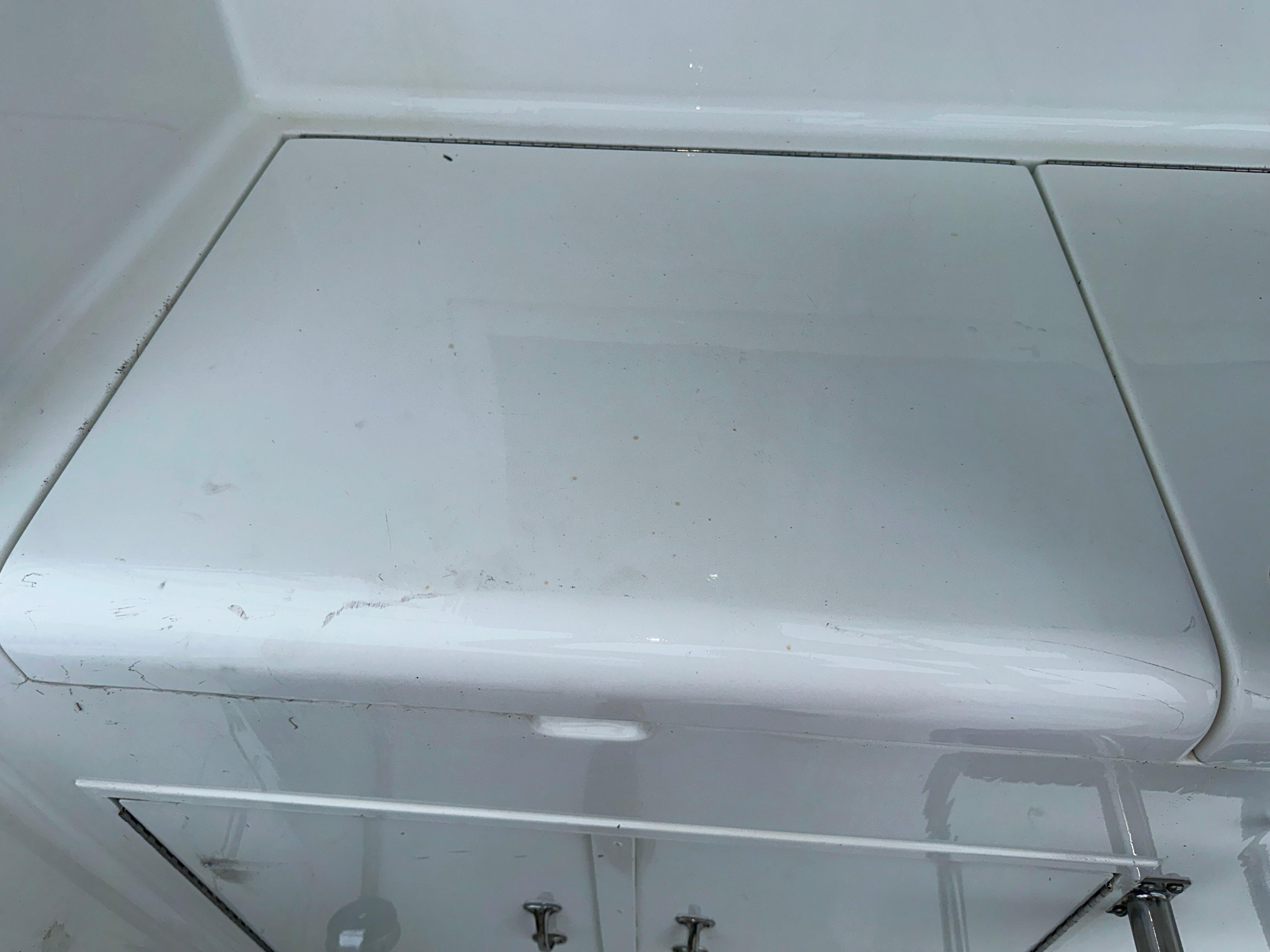 Hatteras 46 Convertible 1994 boat interior storage compartment with white finish.