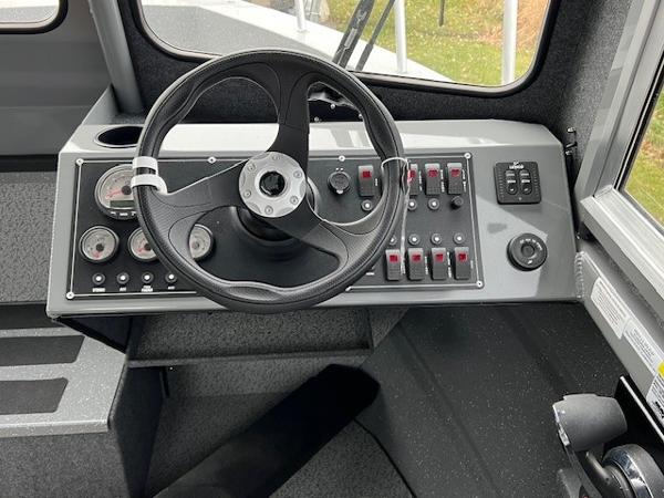 2024 Spartan 220 Maximus boat dashboard with steering wheel and control panel.