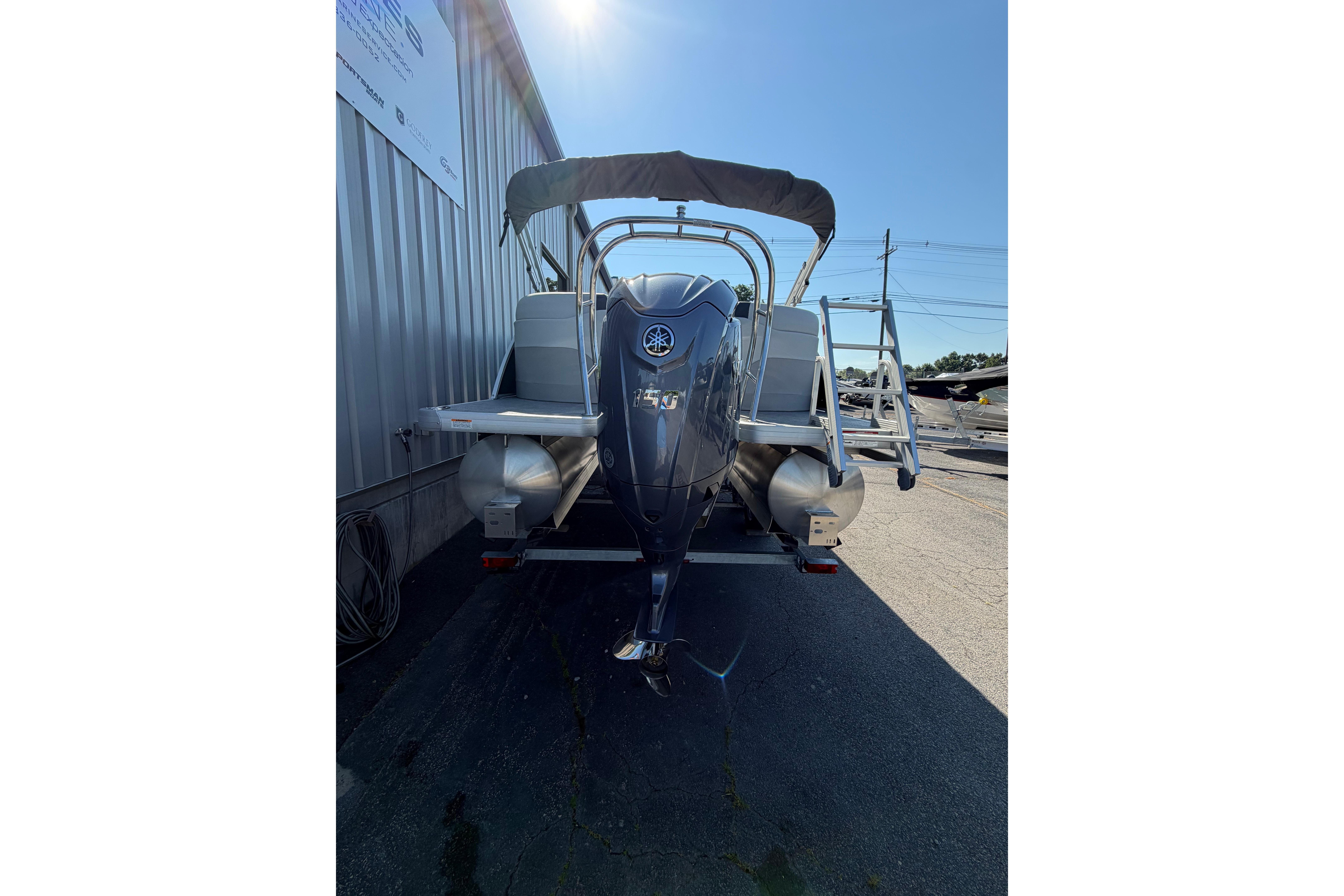 2026 Godfrey Sweetwater 2086 SBC pontoon boat, rear view with motor and ladder.