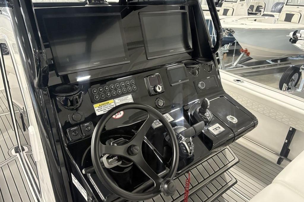 2026 Tidewater 3100 Carolina Bay boat dashboard with steering wheel and control panels.