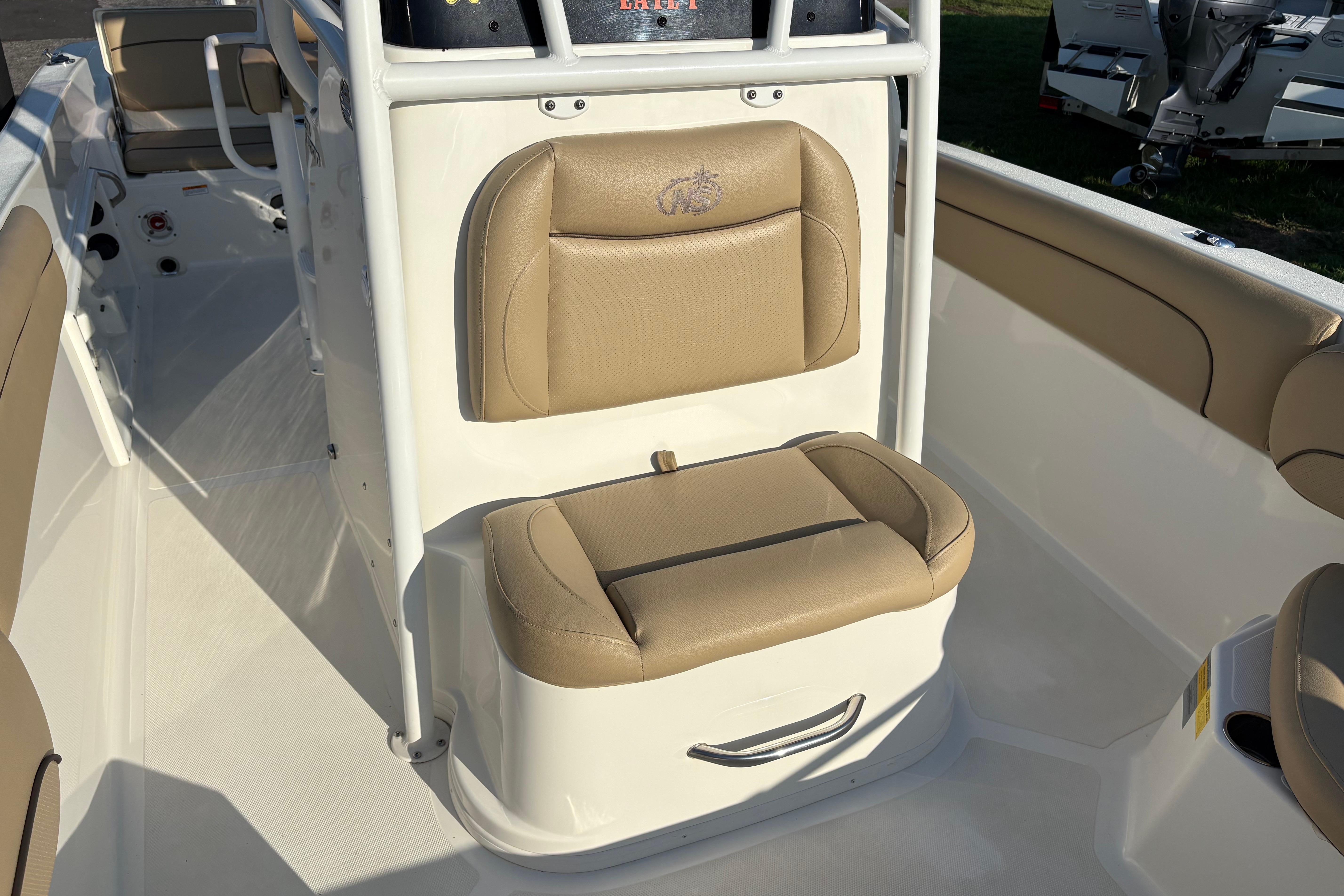 2019 NauticStar 231 Hybrid boat interior with tan seating and white console.