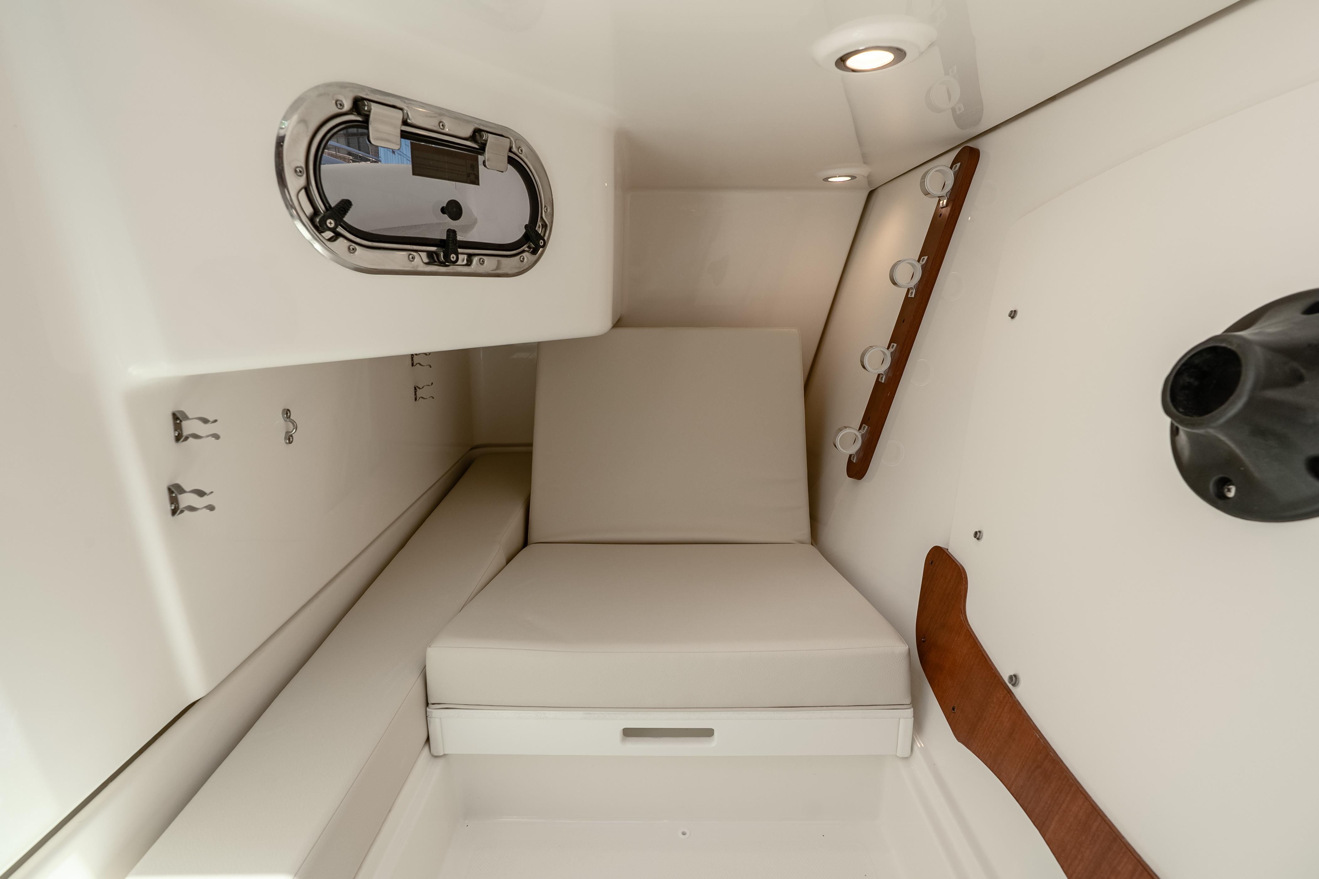 2026 Pursuit DC 326 Dual Console cabin interior with seating and porthole.