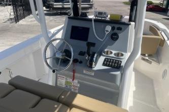 2023 Trophy T24 CC boat console with steering wheel and navigation controls.