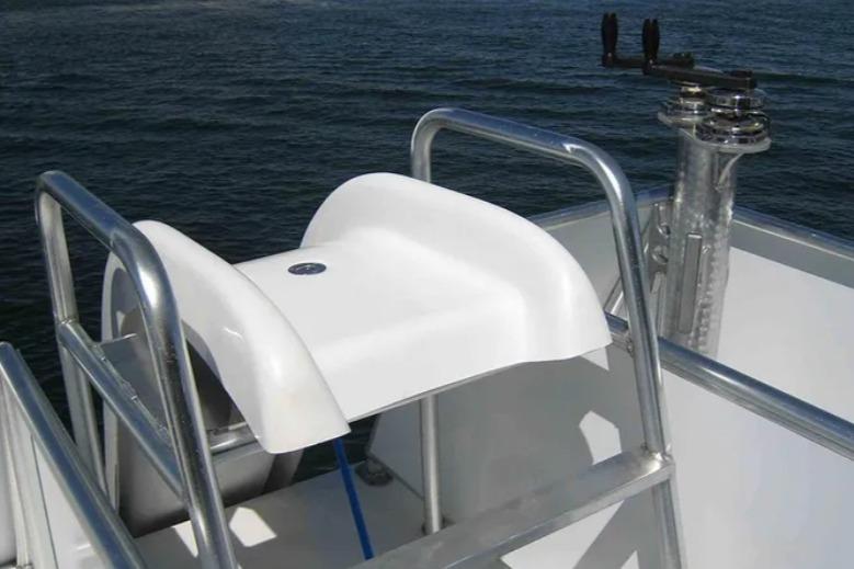 White boat seat on Bravada Helios Share #8, 2012, with metal railing and ocean backdrop.