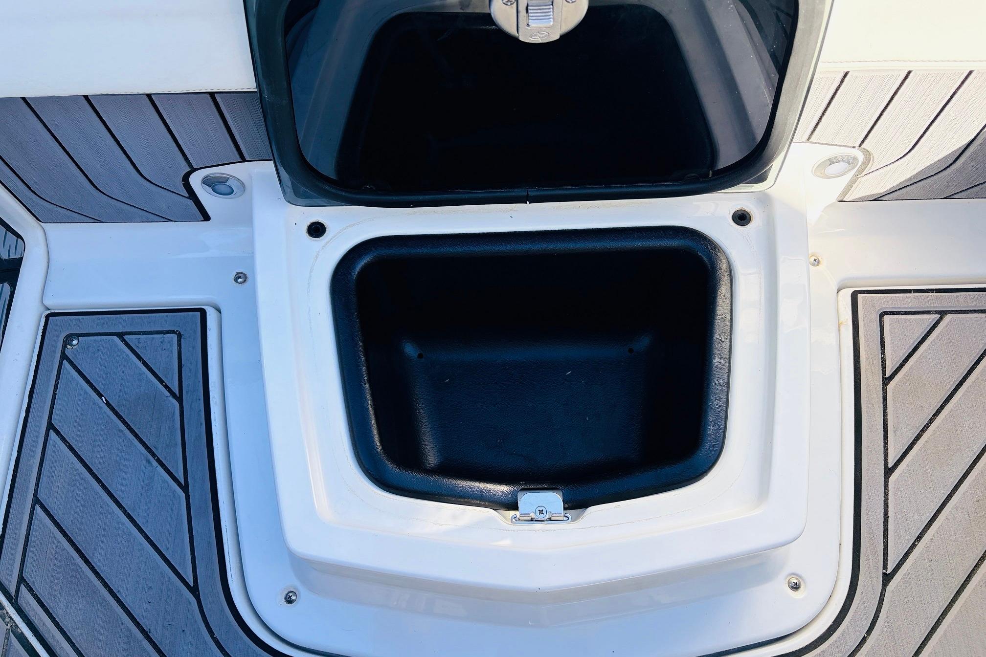 2023 Nautique Super Air Nautique G25 storage compartment with open lid on deck.
