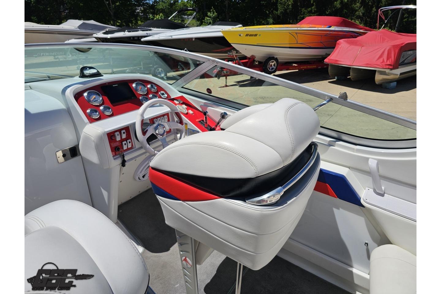 2005 Formula 271 FASTech boat interior with white and red dashboard and seating.
