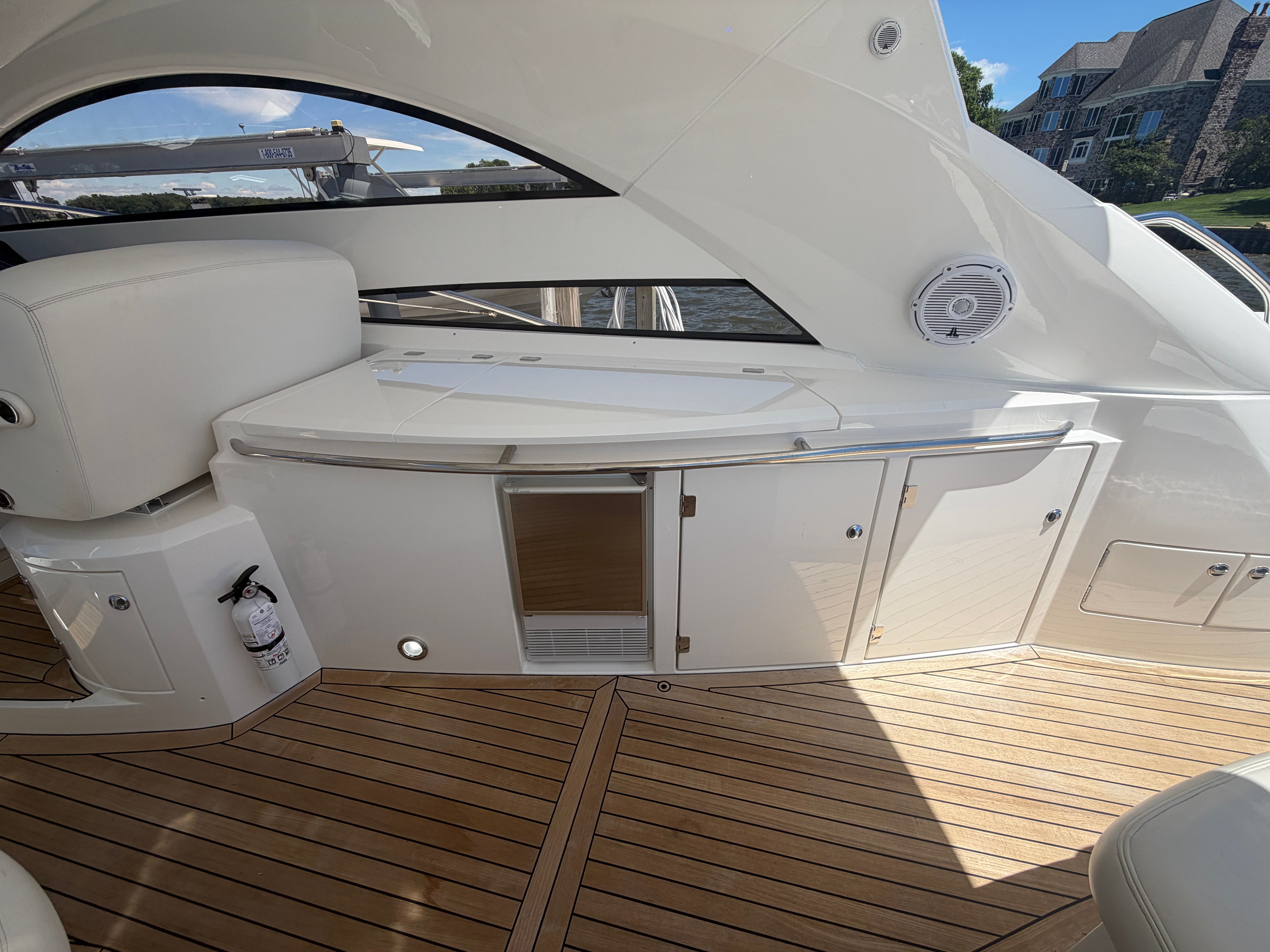The image shows the deck of a 2008 Sunseeker Portofino 53 with sleek wooden flooring.