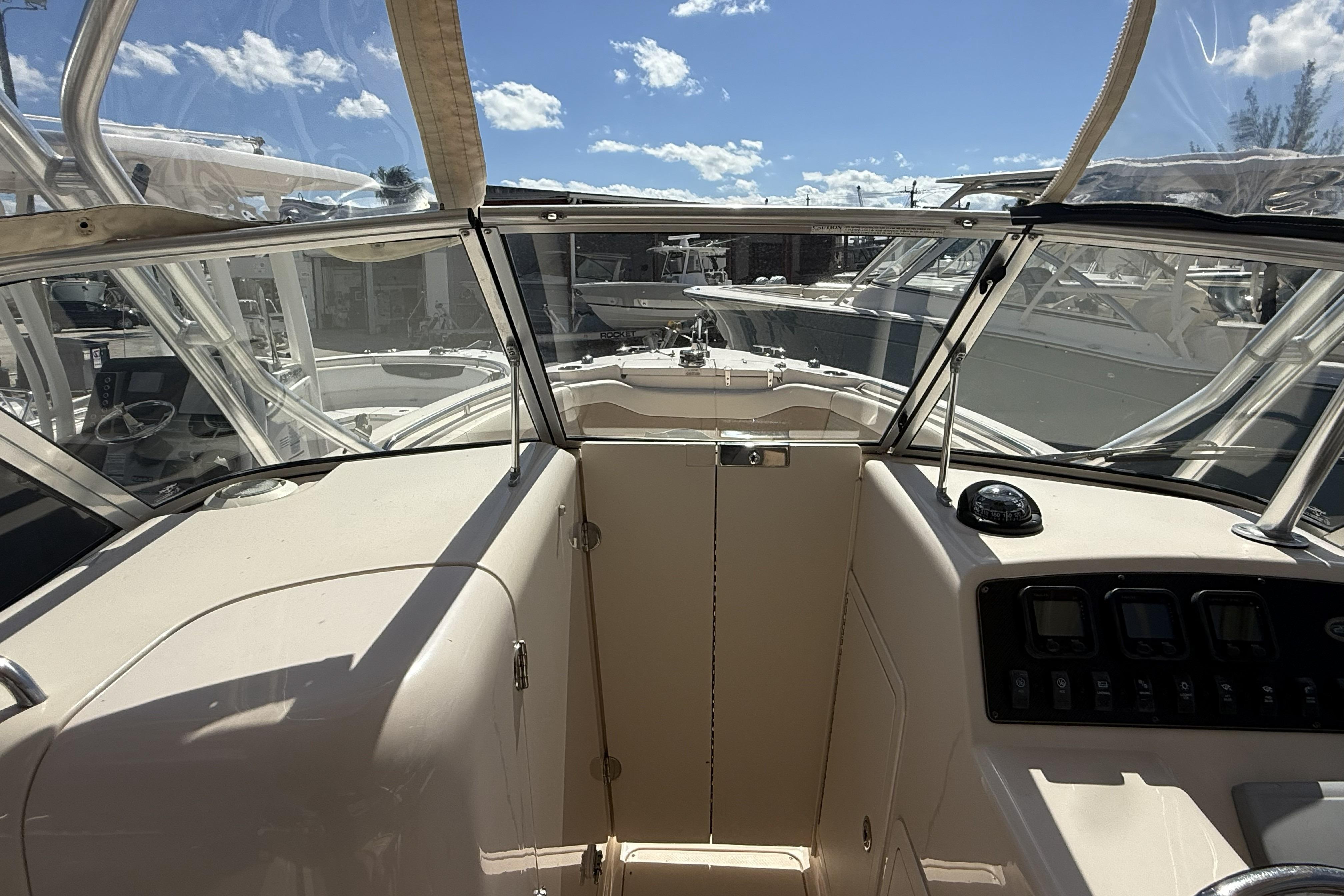 2014 Grady-White Freedom 275 boat interior with clear skies and marina view.
