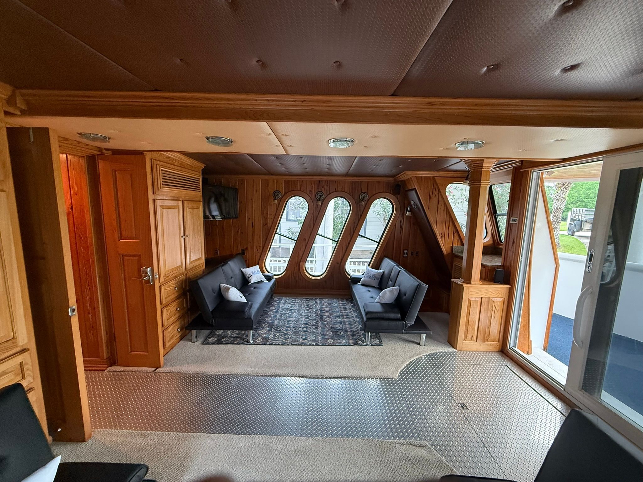 Interior of a boat with wooden walls and modern sofas.