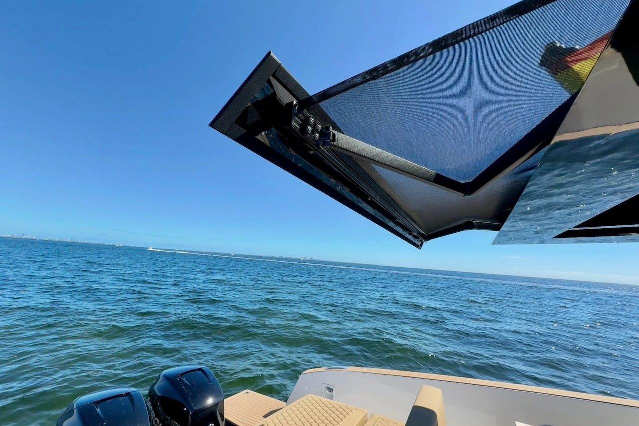 2023 Tesoro T38 boat with sunshade, ocean view, and dual engines.