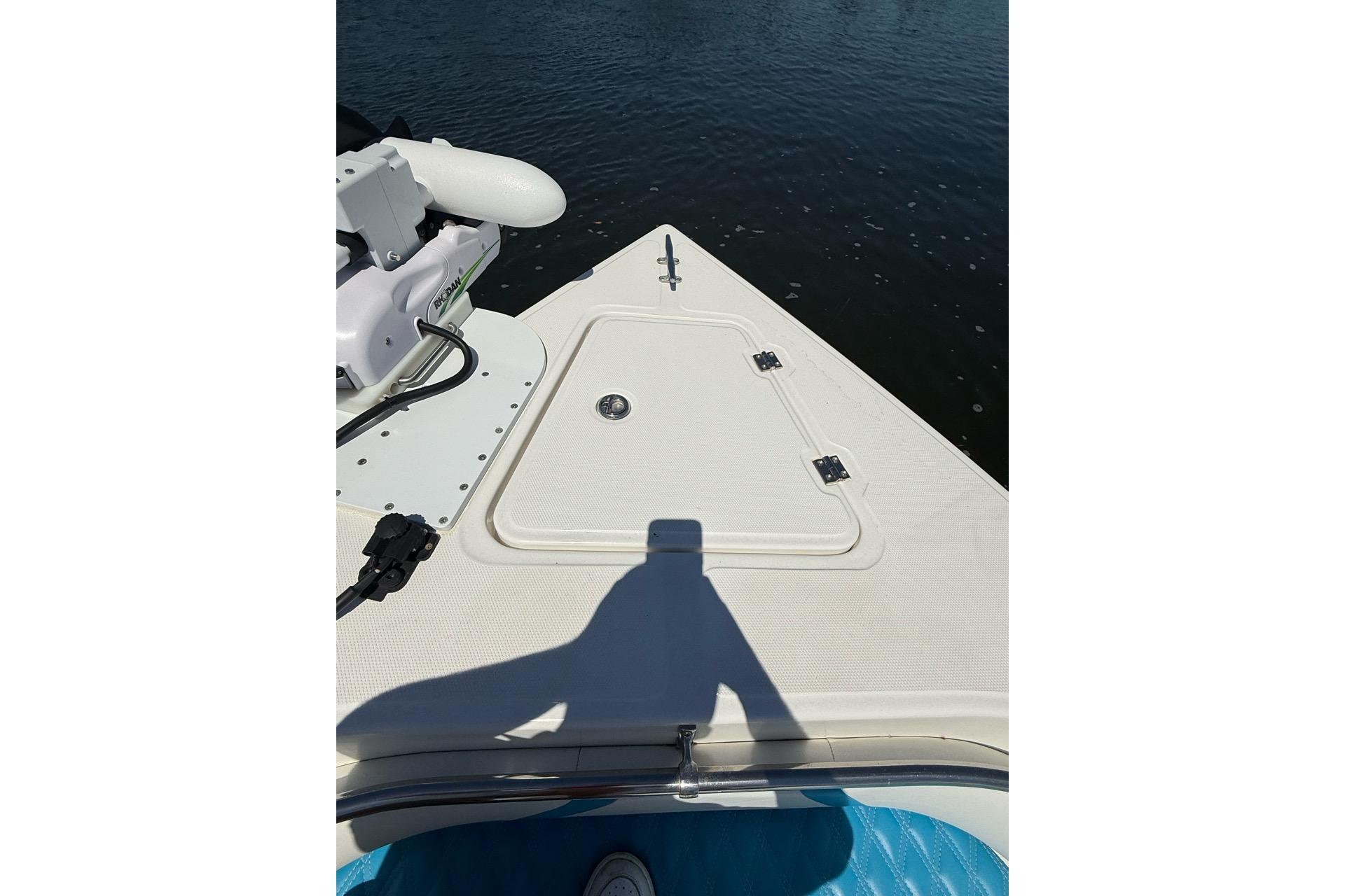 Bow of 2021 Custom Infusion 34 CC boat with hatch and water view.