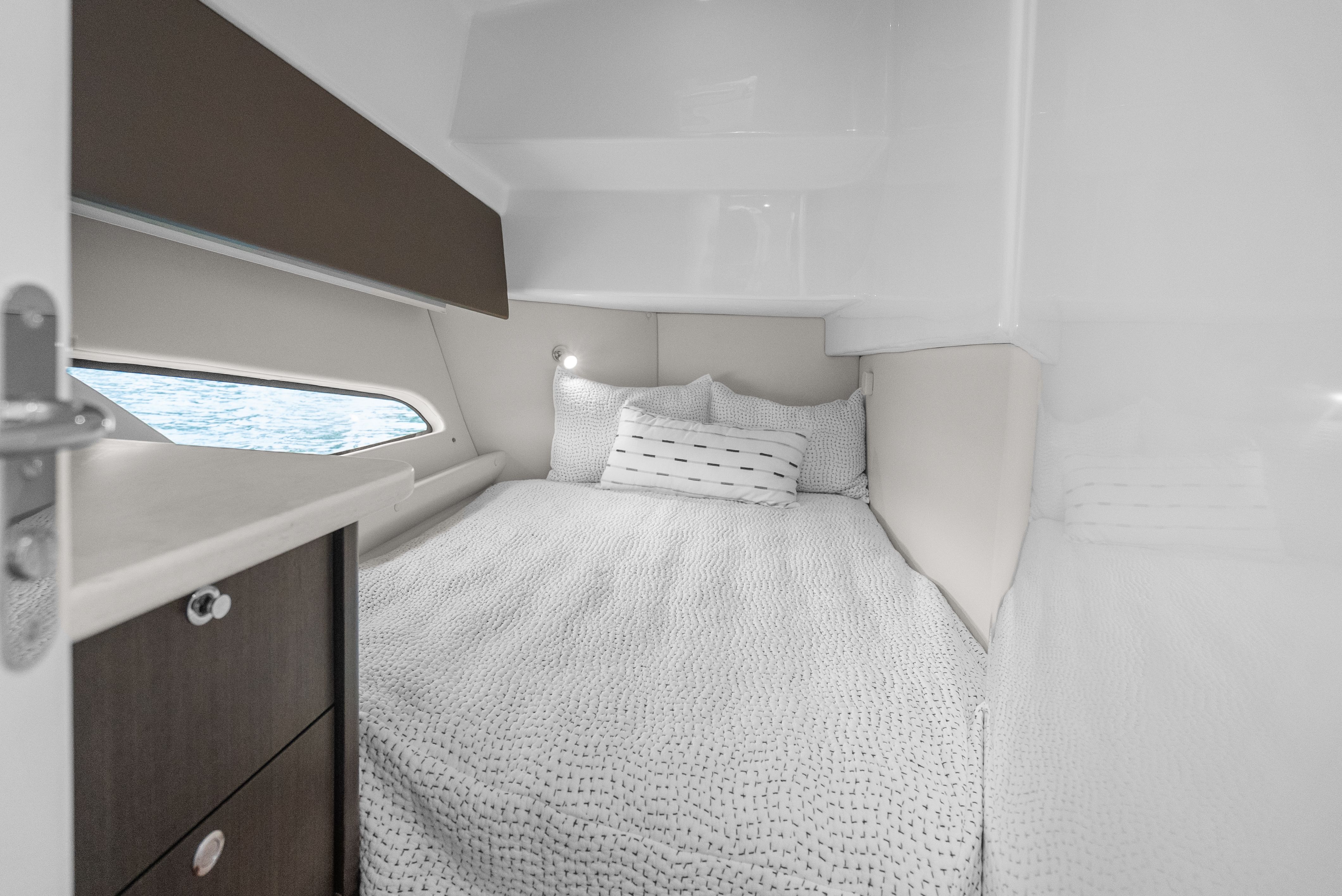 Interior of 2024 Intrepid 477 Evolution with cozy bed and window view.