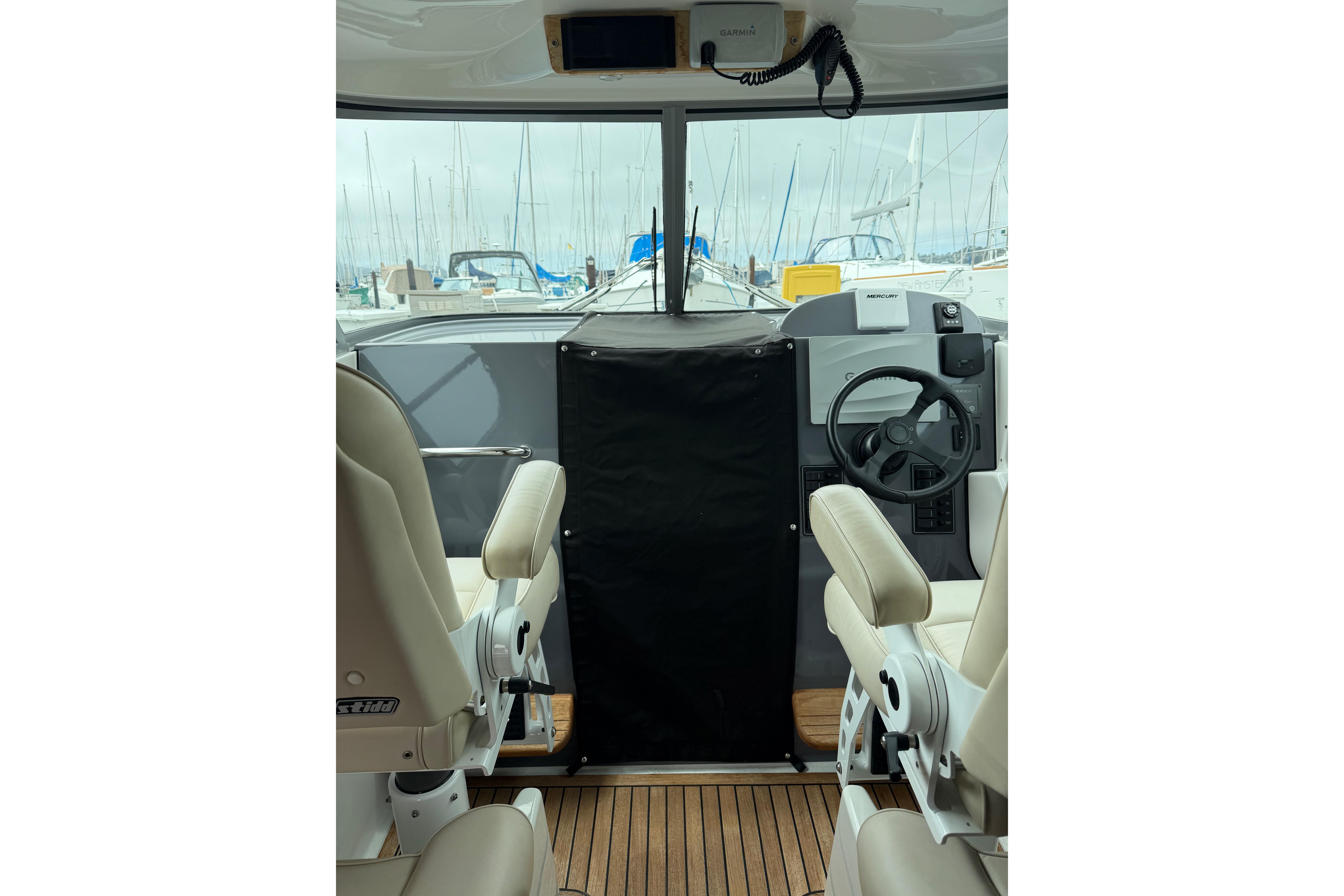 Interior view of 2016 Protector Targa 30 boat with steering wheel and seating.
