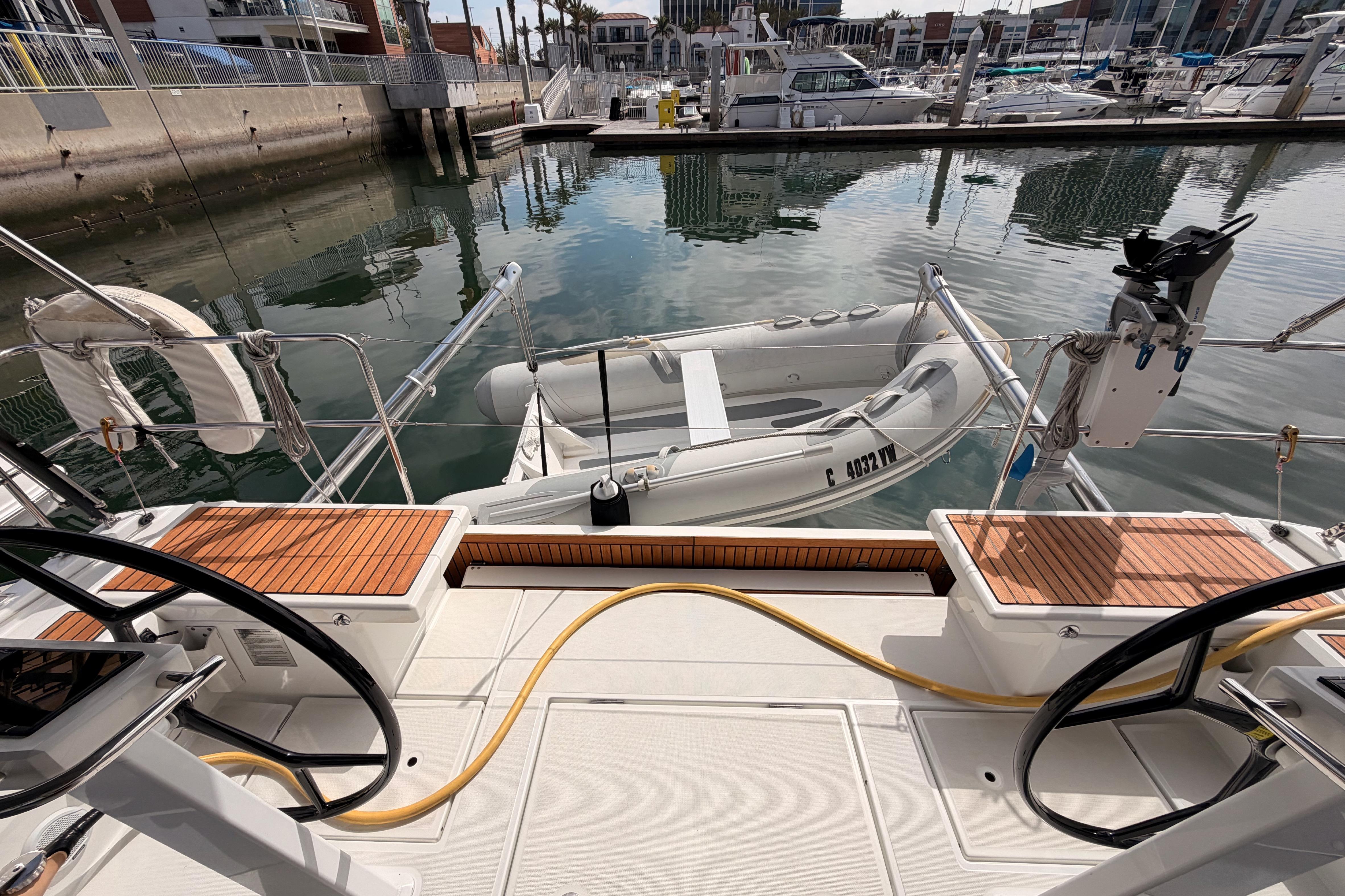 Beneteau Oceanis 46.1 yacht deck with dinghy, docked in a marina, 2020 model.