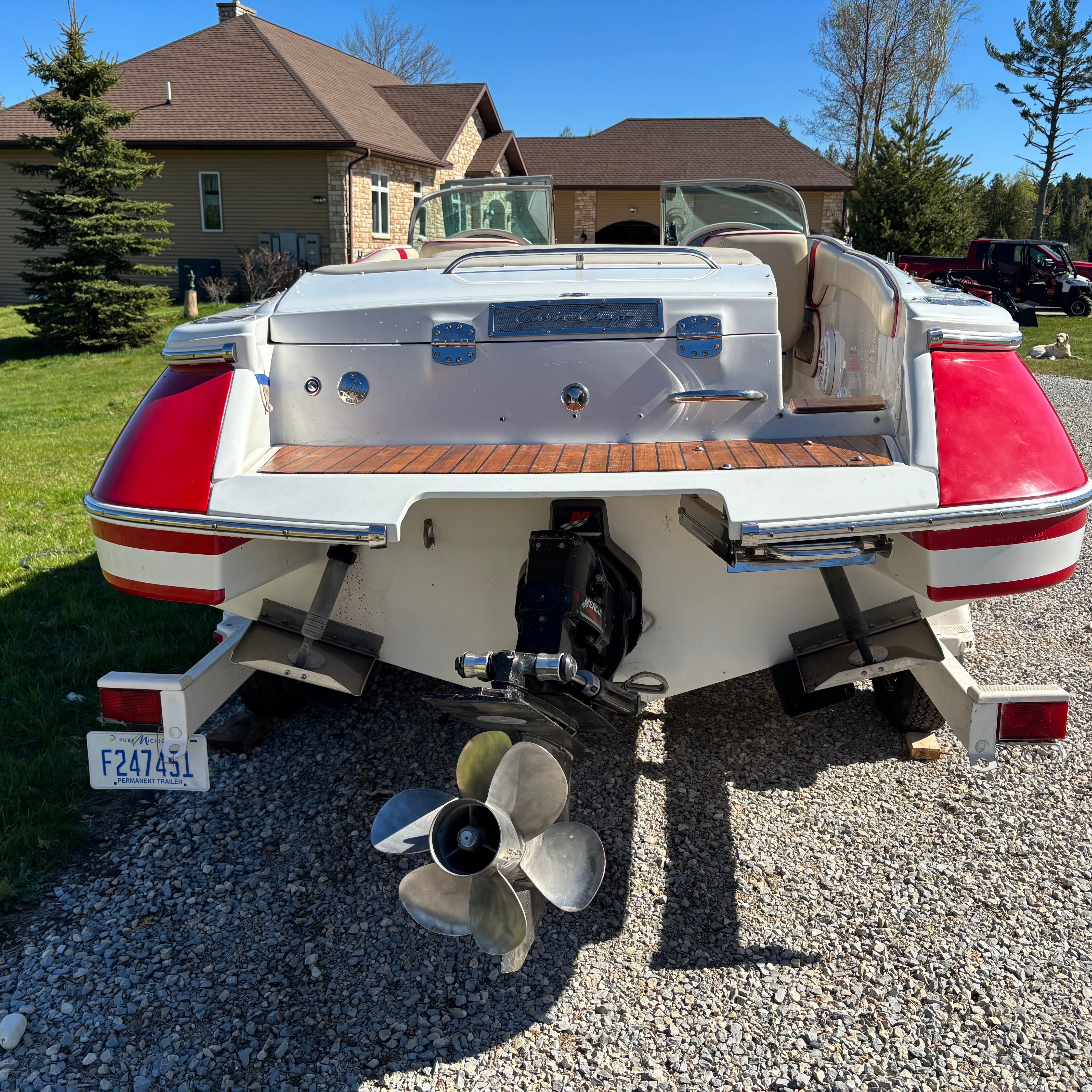 The image shows a 2003 Chris-Craft Launch 22 boat on a gravel path.