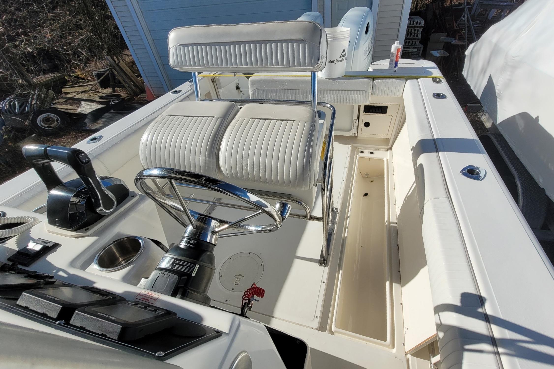 1999 Boston Whaler 26 Outrage boat interior with steering wheel and seating.