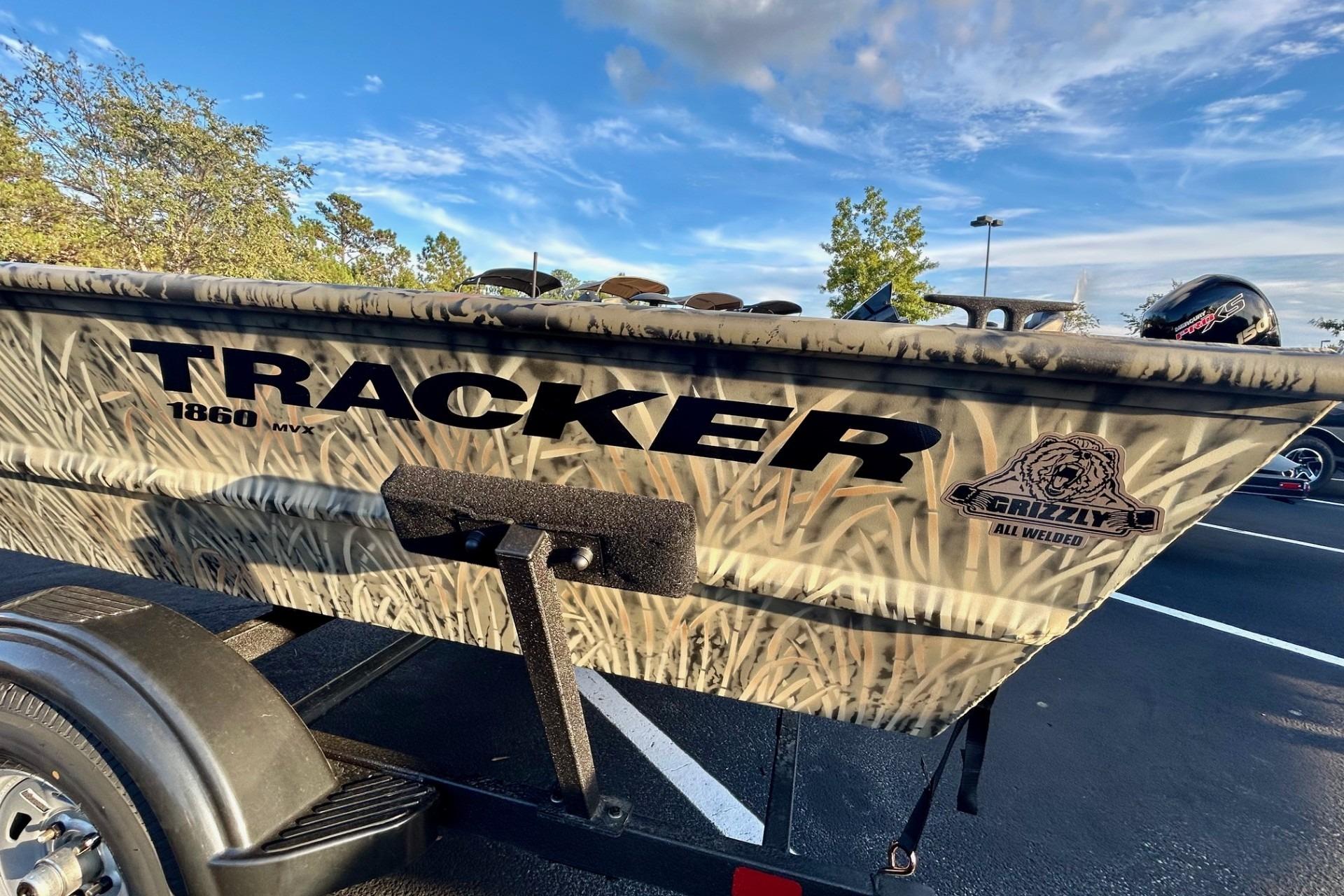 2026 Tracker Grizzly 1860 Utility boat with camouflage design on a trailer.