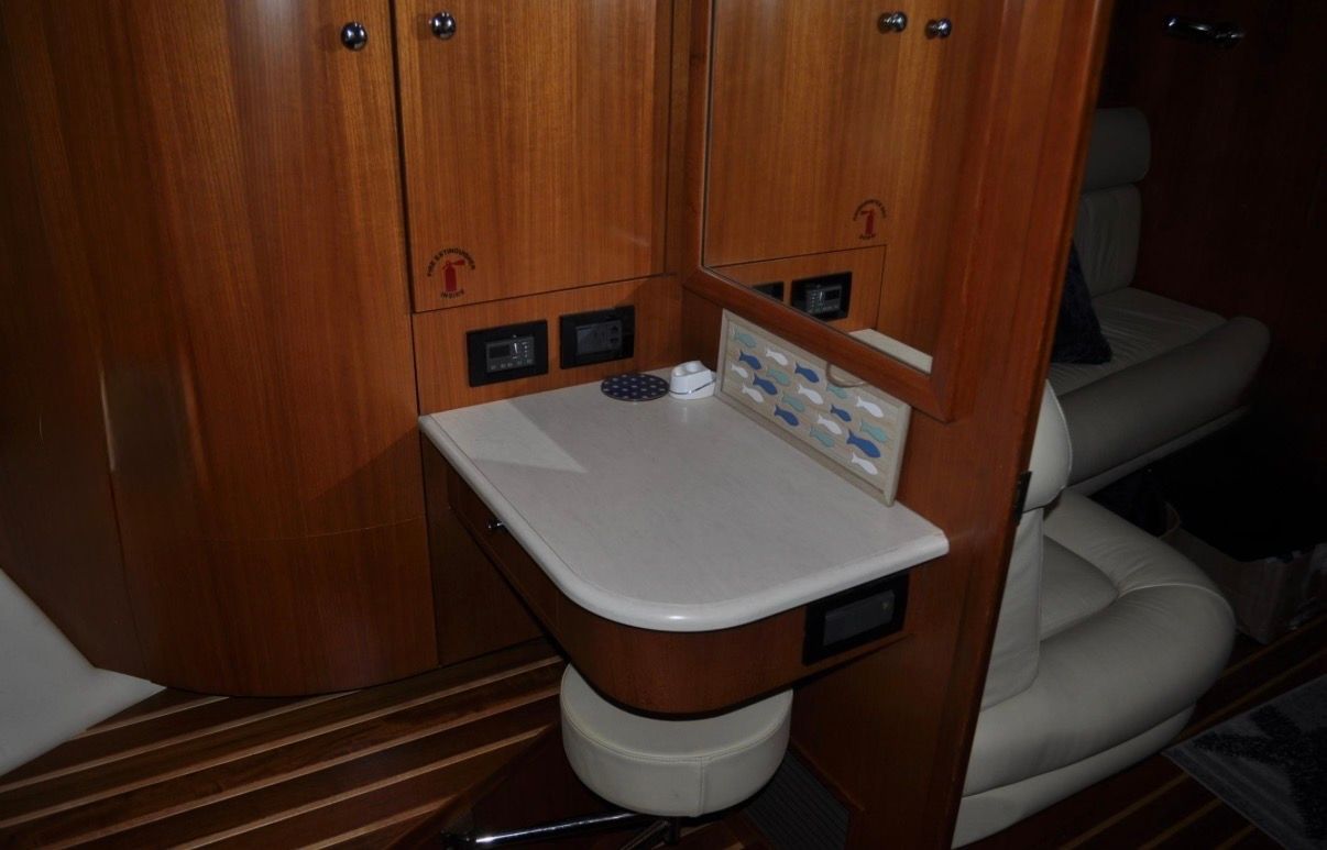 Interior of the 2005 Tiara Yachts 5200 Sovran with wood furnishings and a small table.