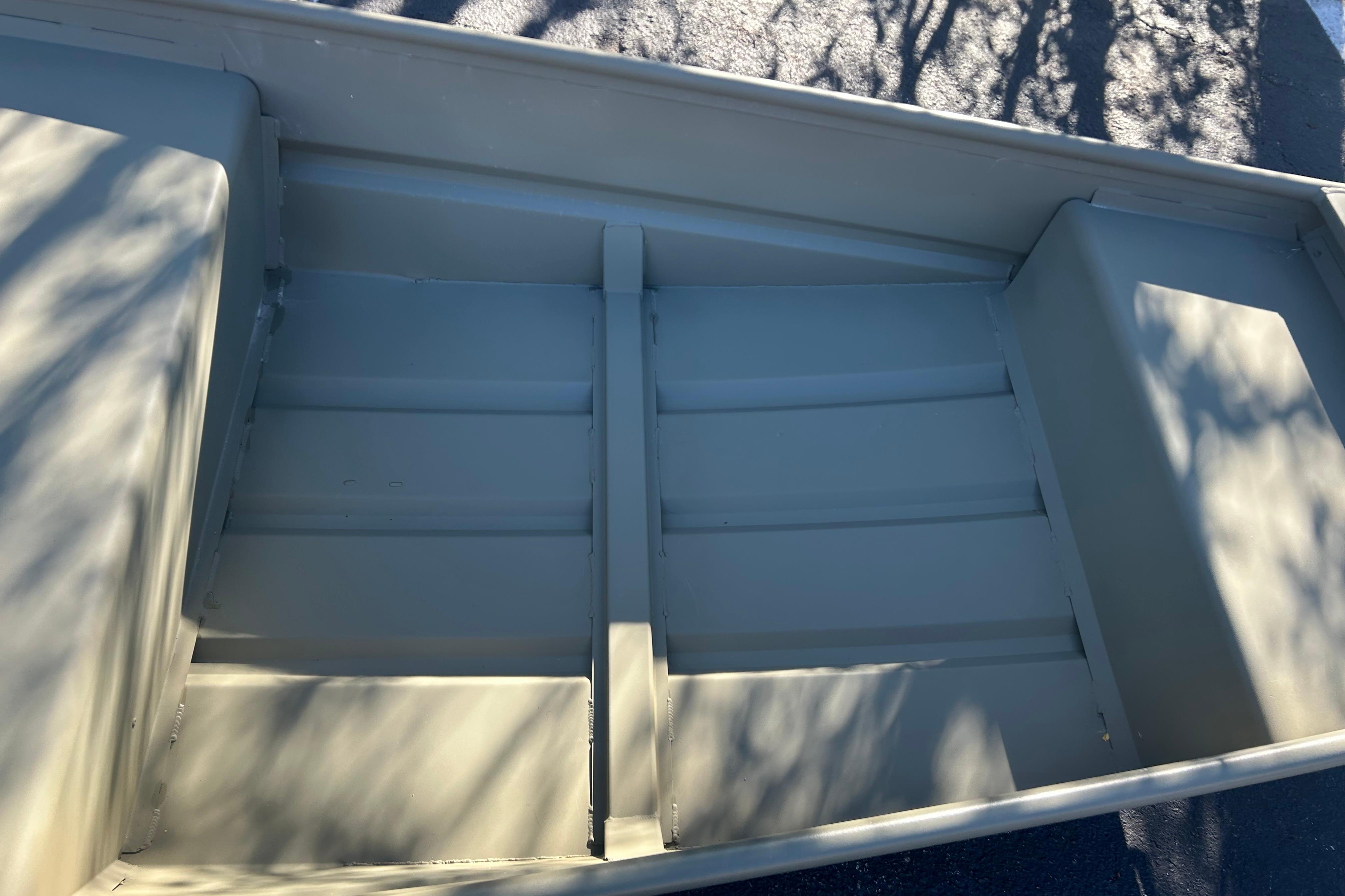 2026 Tracker Grizzly 14 Jon boat interior with shadow patterns on seats.
