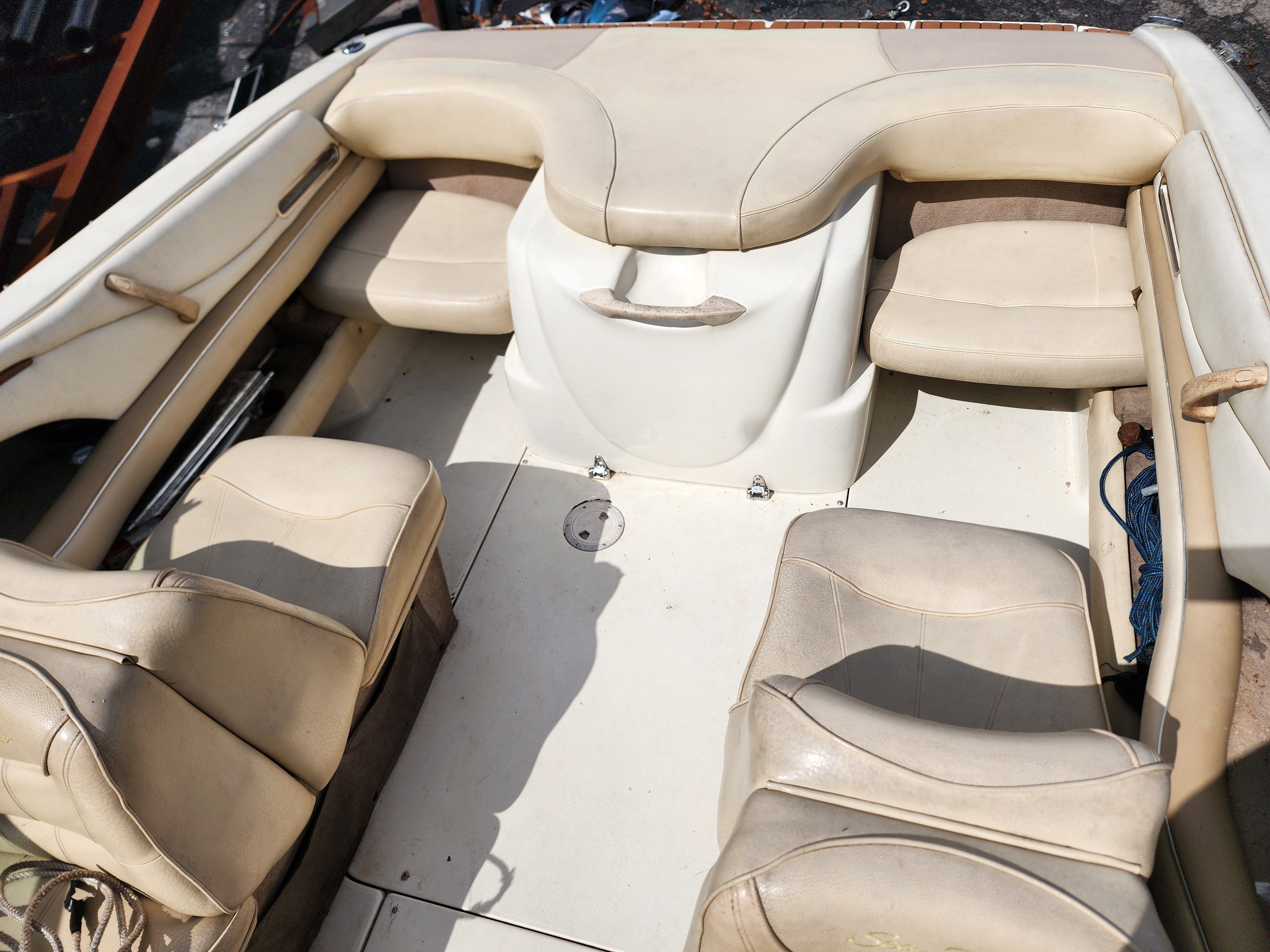 Interior view of a 1999 Sea Ray 210 Bowrider Signature with beige seating.