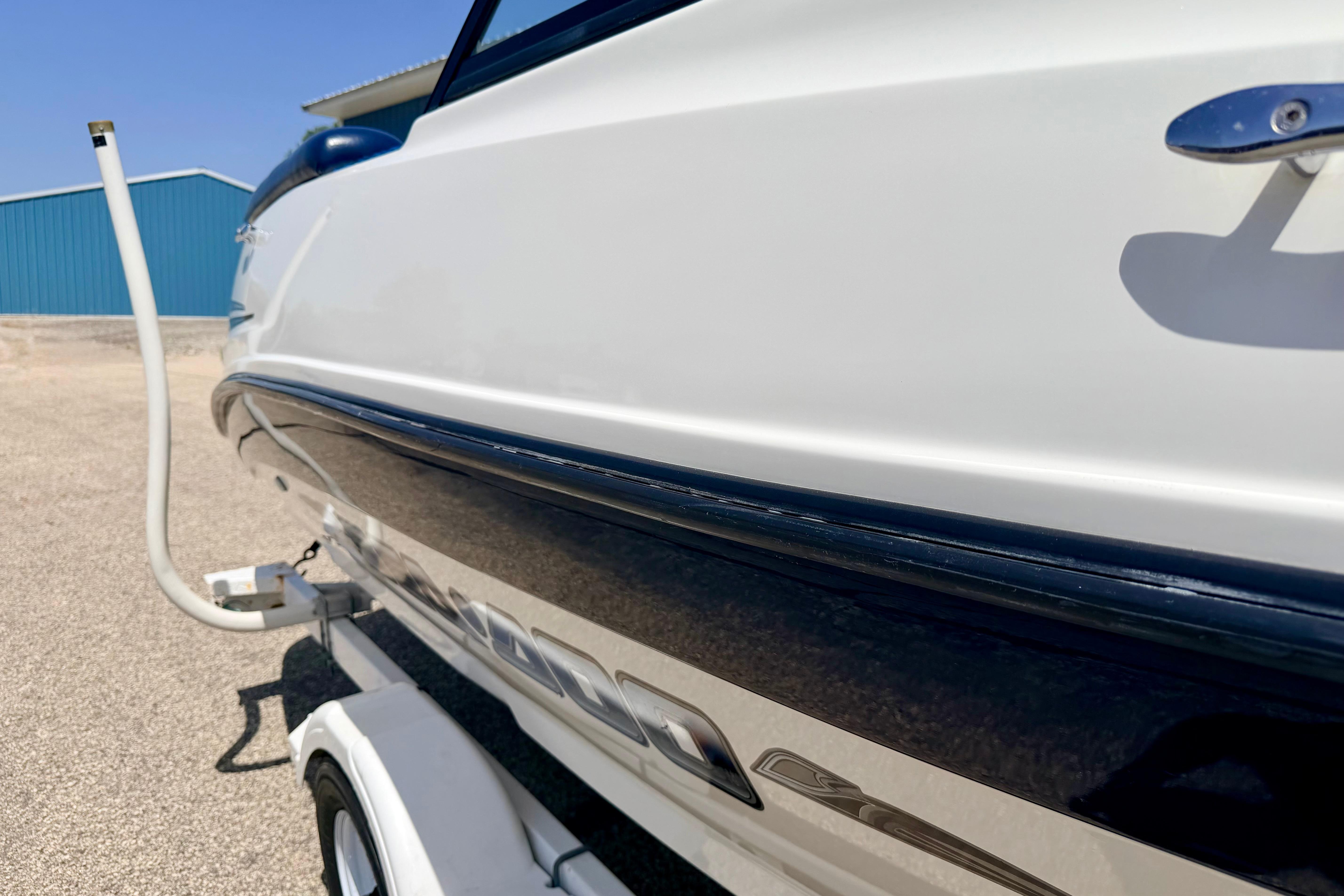 2004 Bombardier SEADOO Utopia 185 boat on trailer, side view, outdoors.