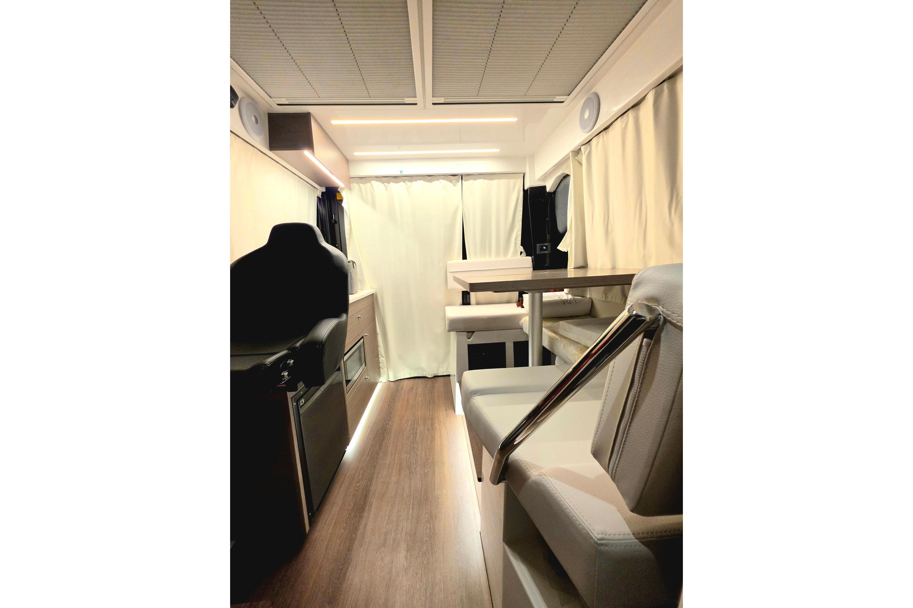 Interior of 2026 Jeanneau NC 895 Series 2 boat, featuring modern seating and wood flooring.