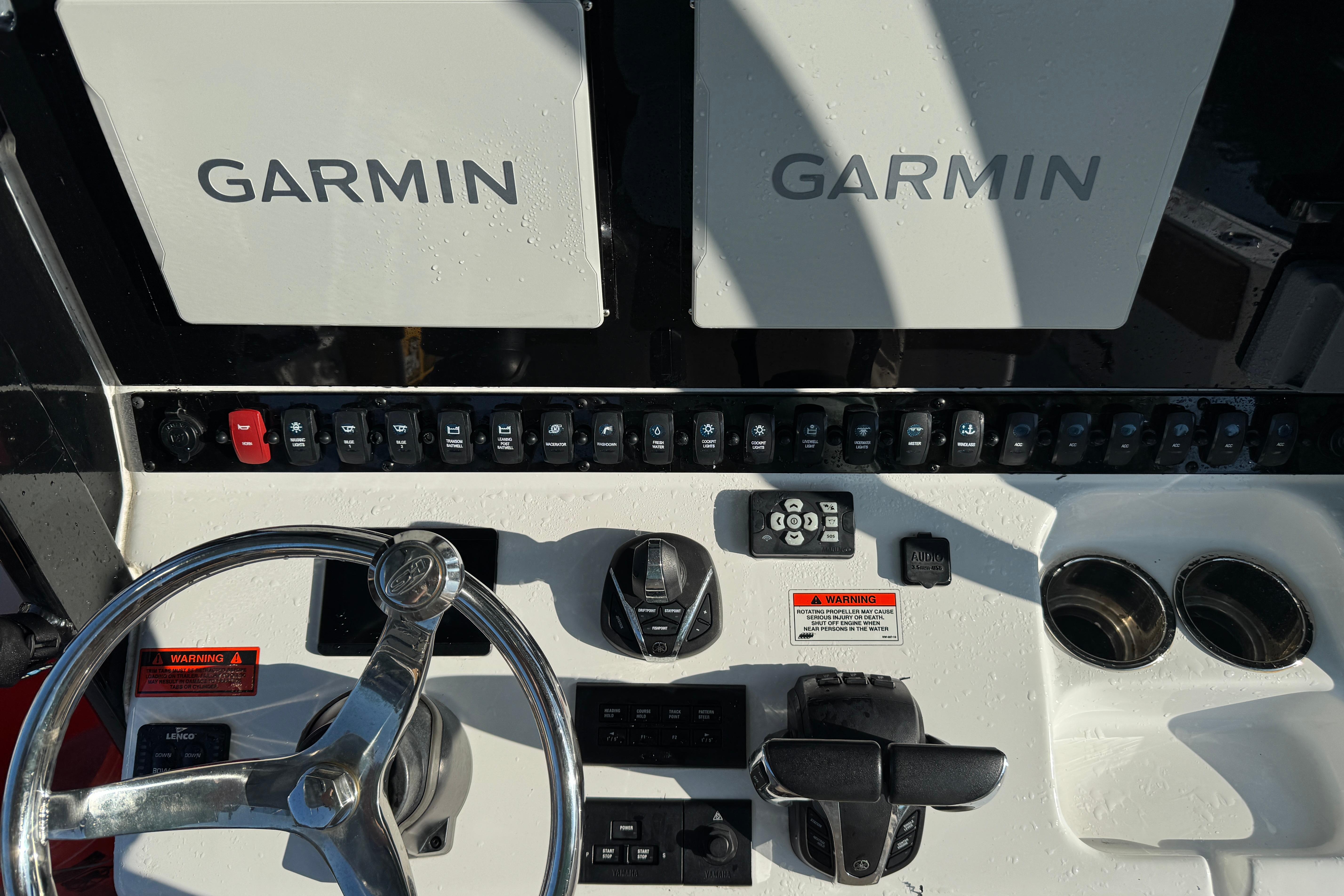Control panel of 2021 Sea Hunt Gamefish 30 with Garmin displays and steering wheel.