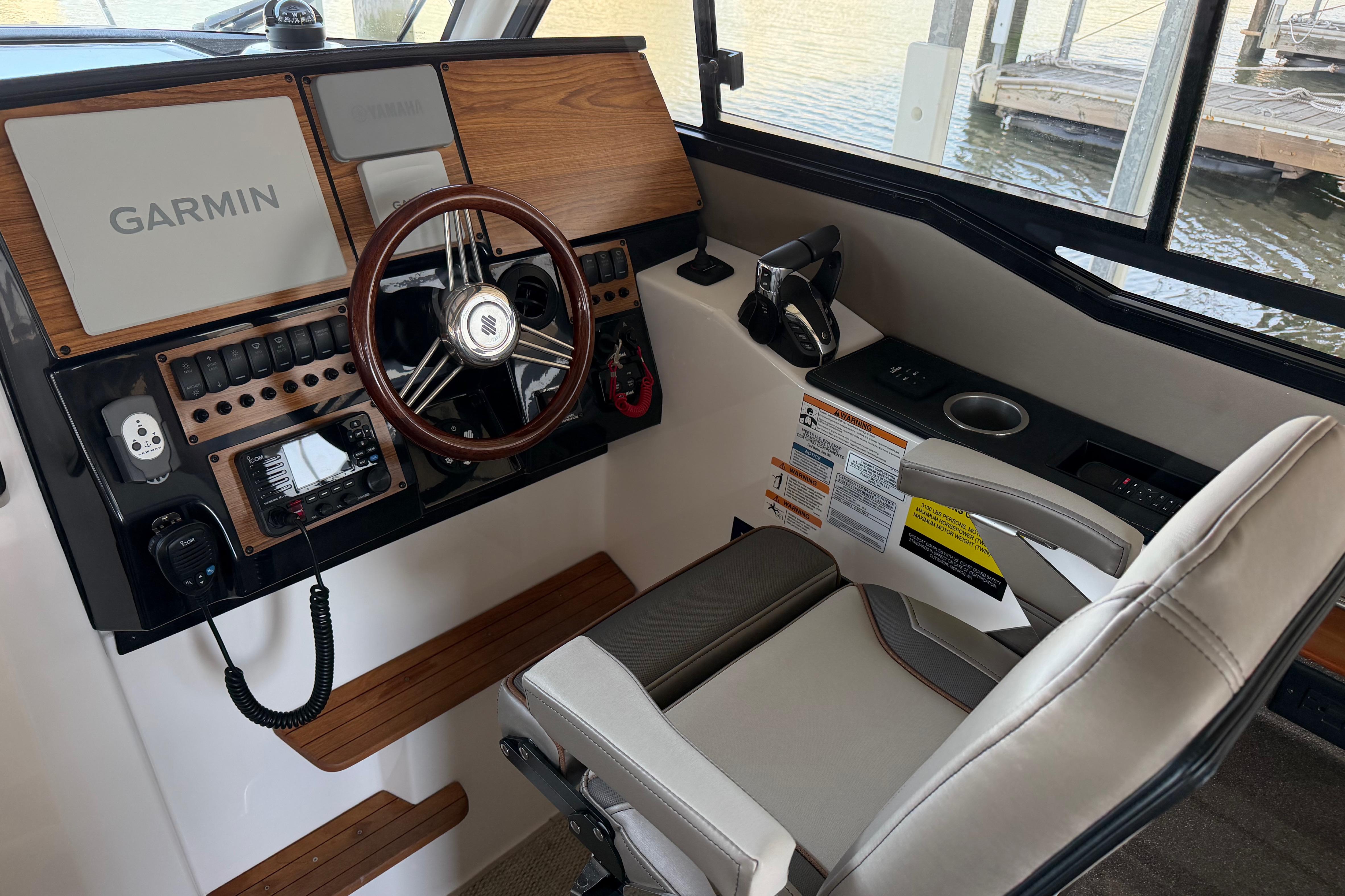 2023 Cutwater C-288 Coupe helm with Garmin navigation, wood accents, and comfortable seating.