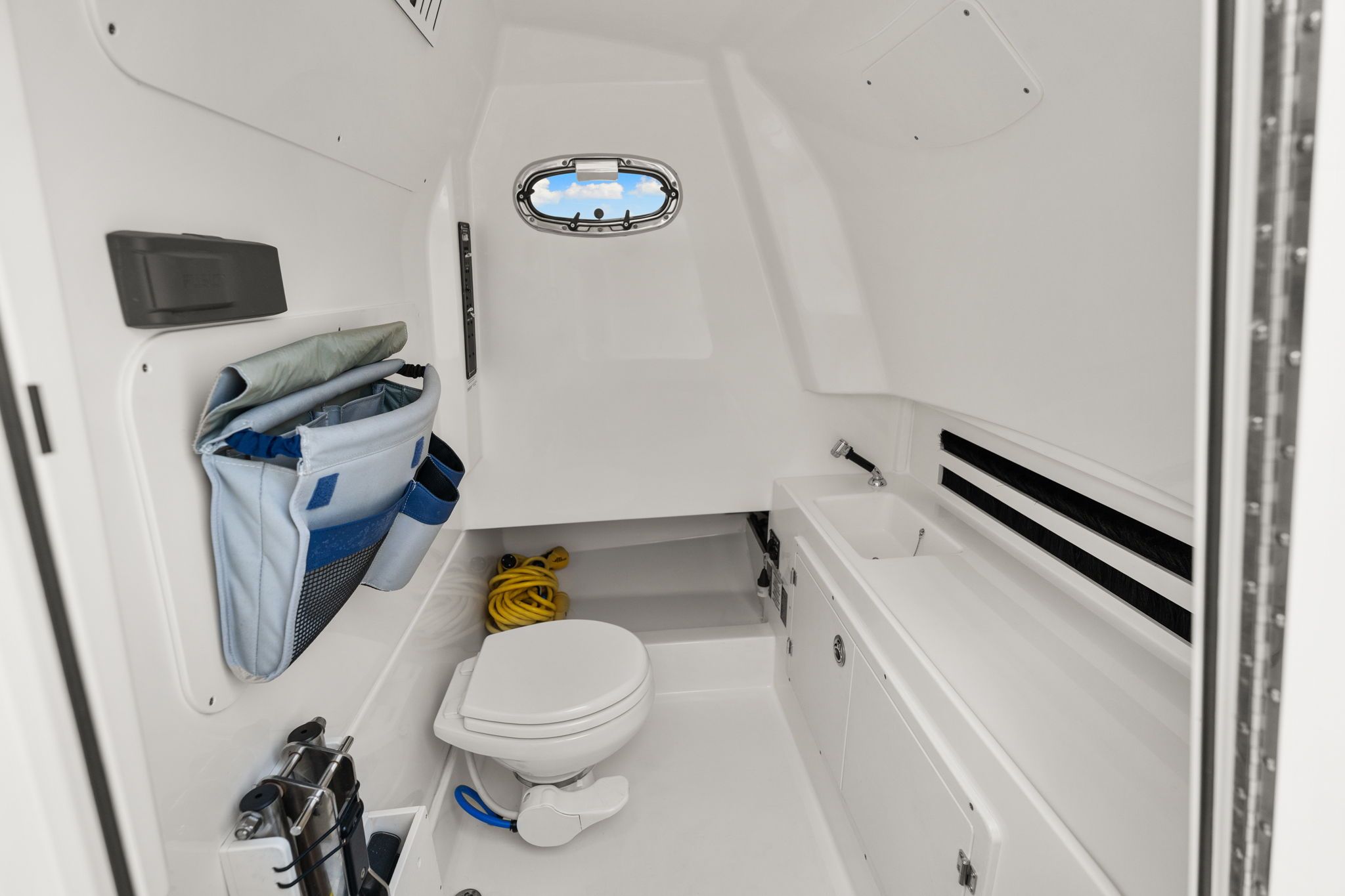 Interior of 2022 Boston Whaler 330 Outrage with toilet and storage.