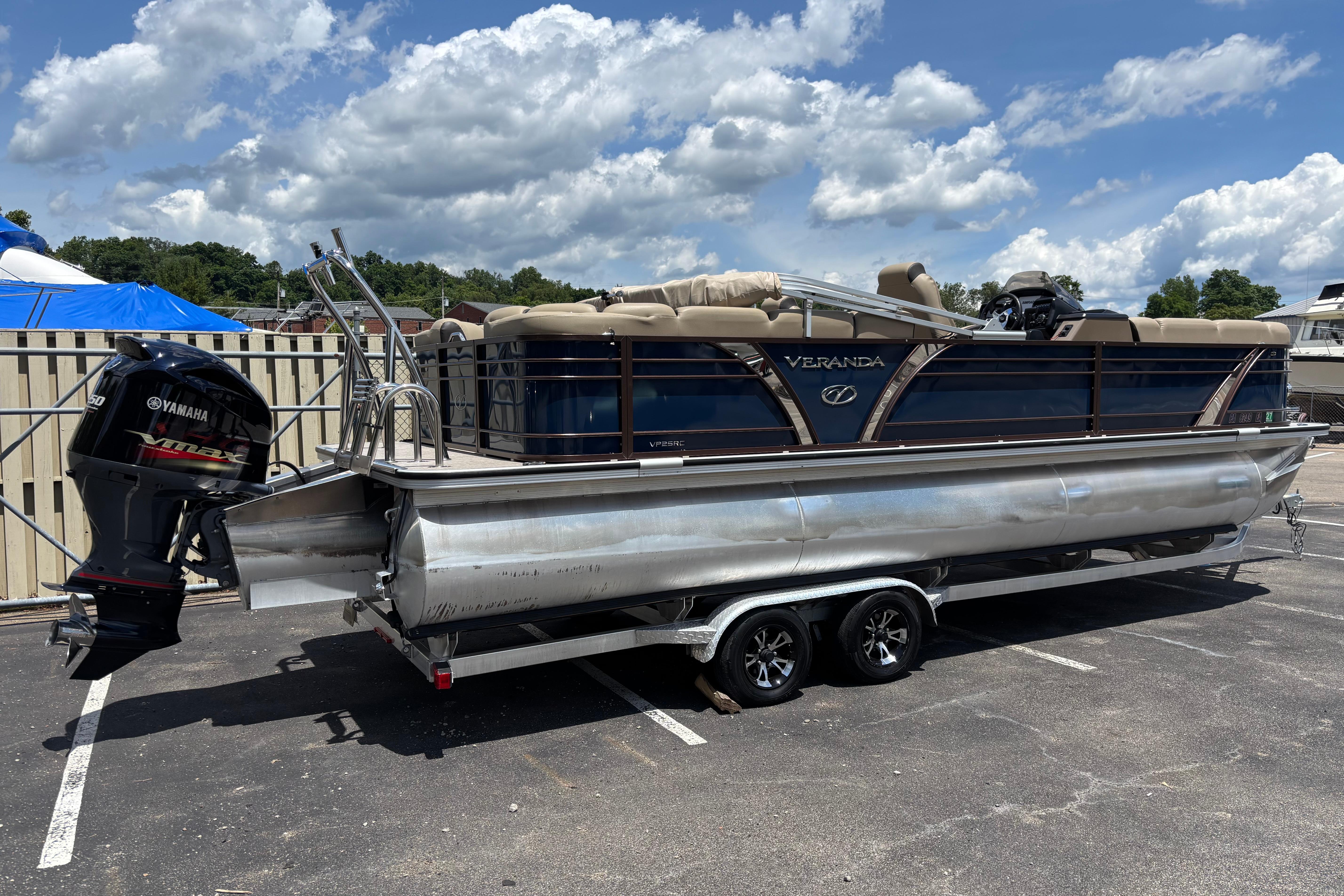 2021 Veranda VP25RC pontoon boat with Yamaha engine, parked outdoors under a cloudy sky.