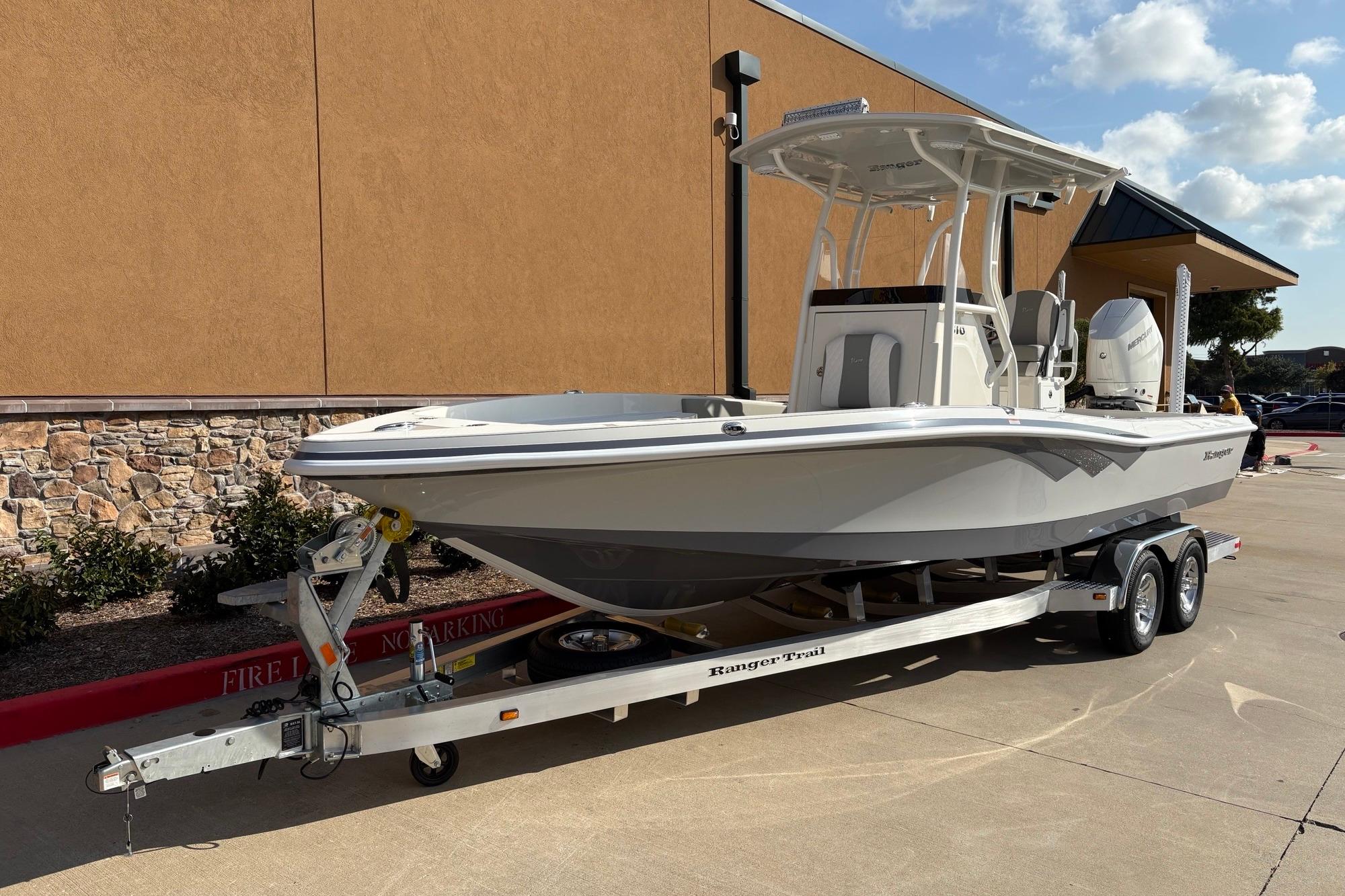2026 Ranger 2510 Bay boat on trailer, parked outdoors, sunny day.