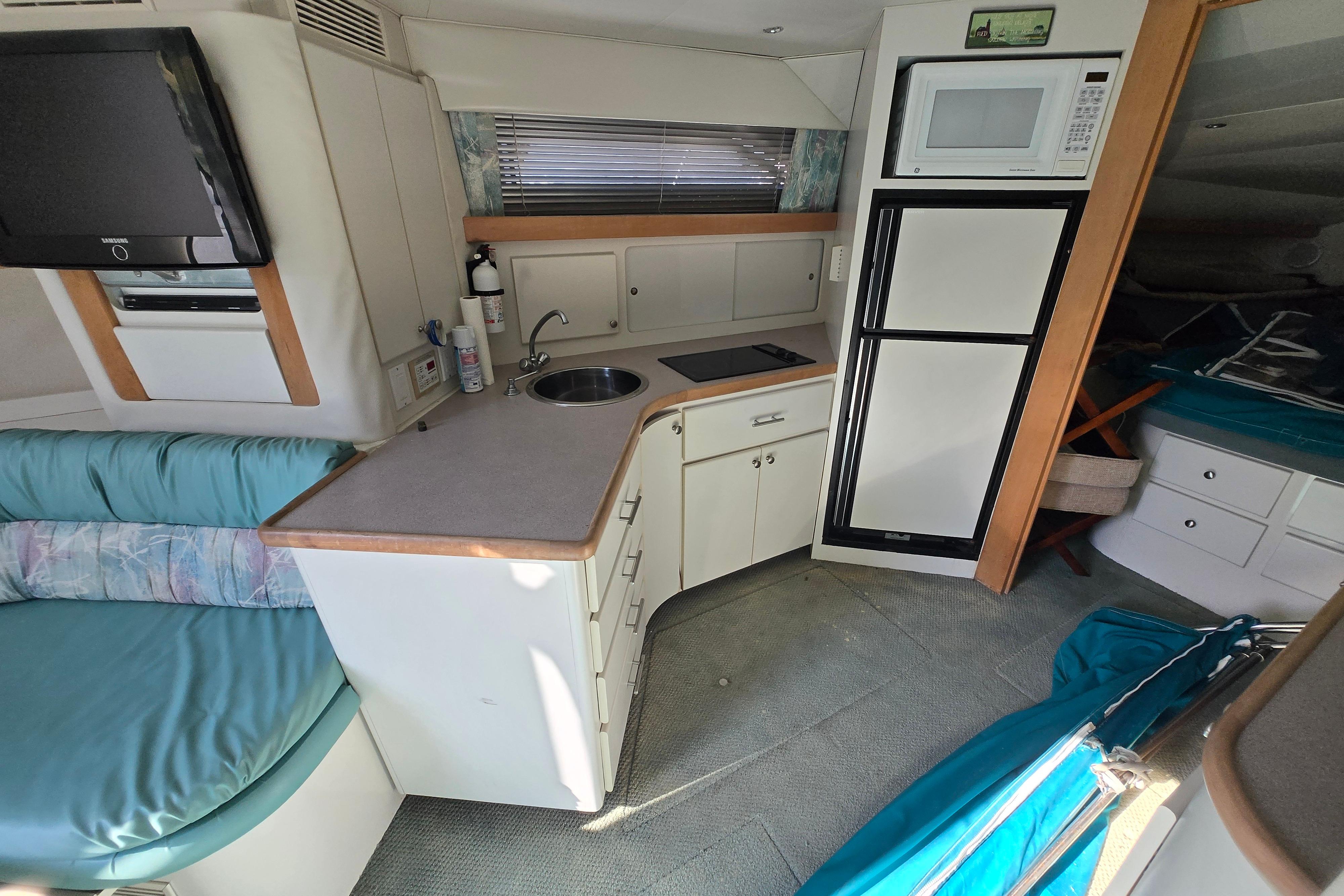 Interior of 1994 Carver 380 Santego yacht with kitchenette and seating area.