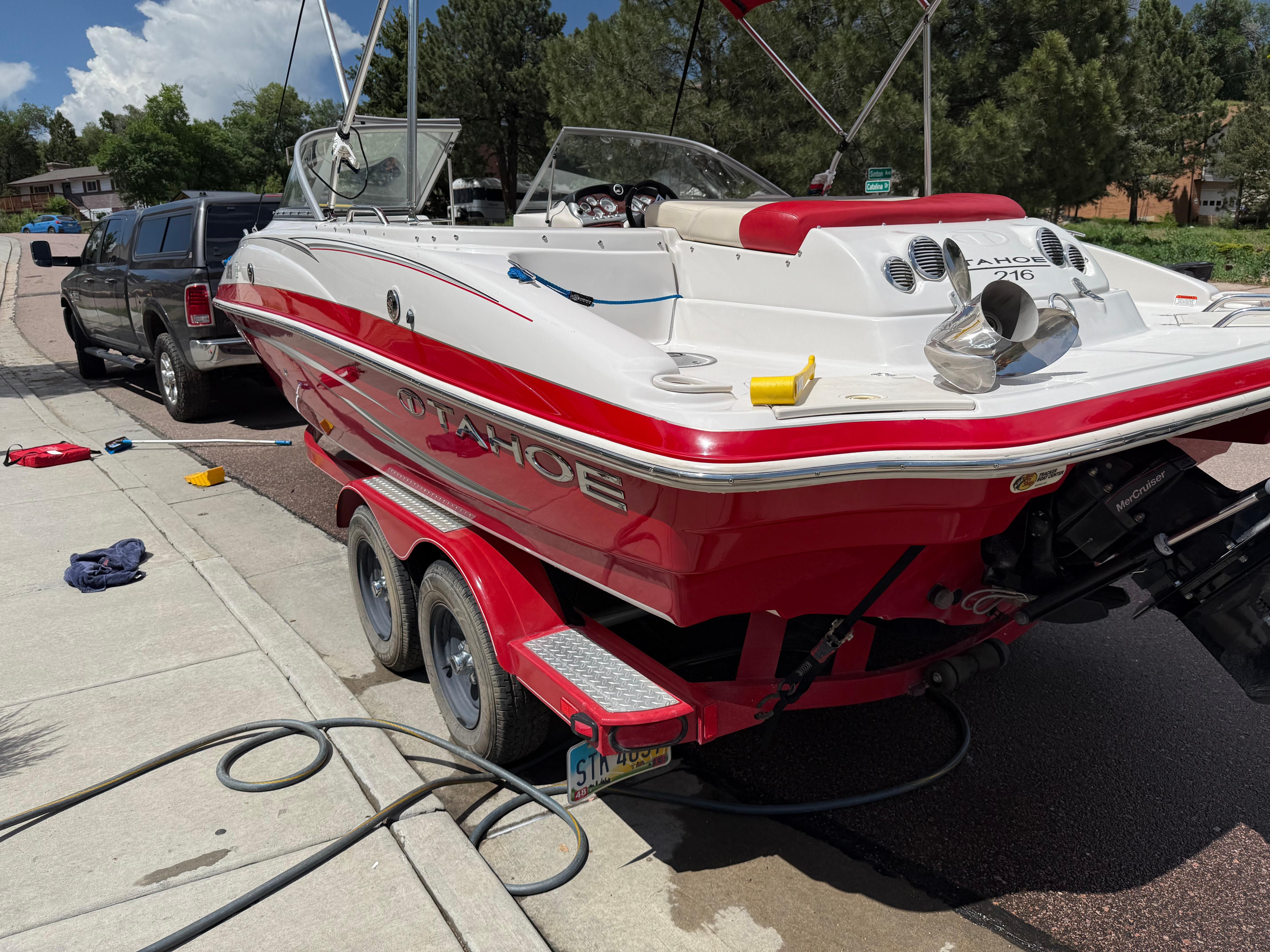 Red 2011 Tahoe 216 WT boat on trailer.