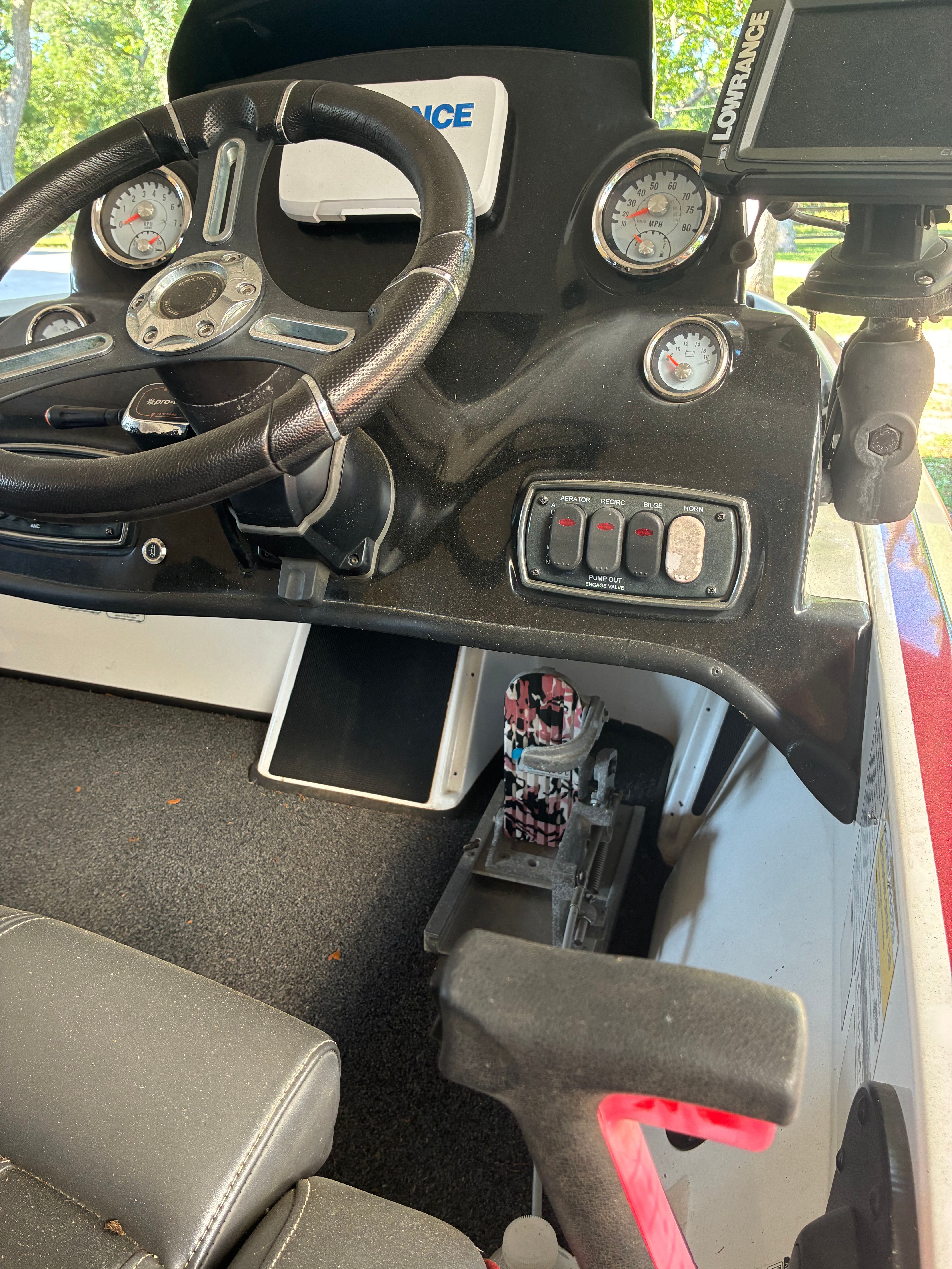 The cockpit of a Nitro Z18 boat with steering wheel and instruments.